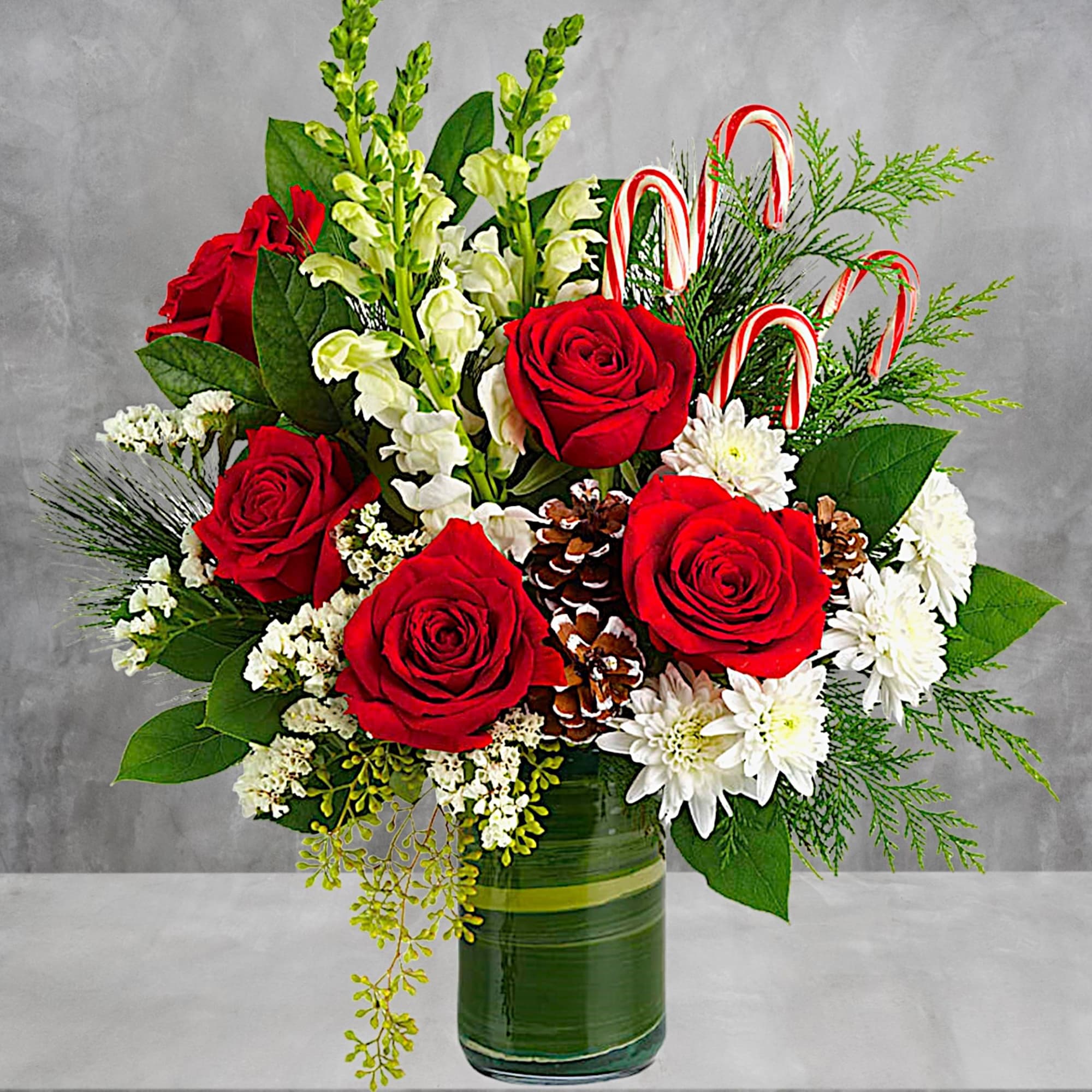 An instant Christmas party, this festive arrangement bursts with fresh blooms of
