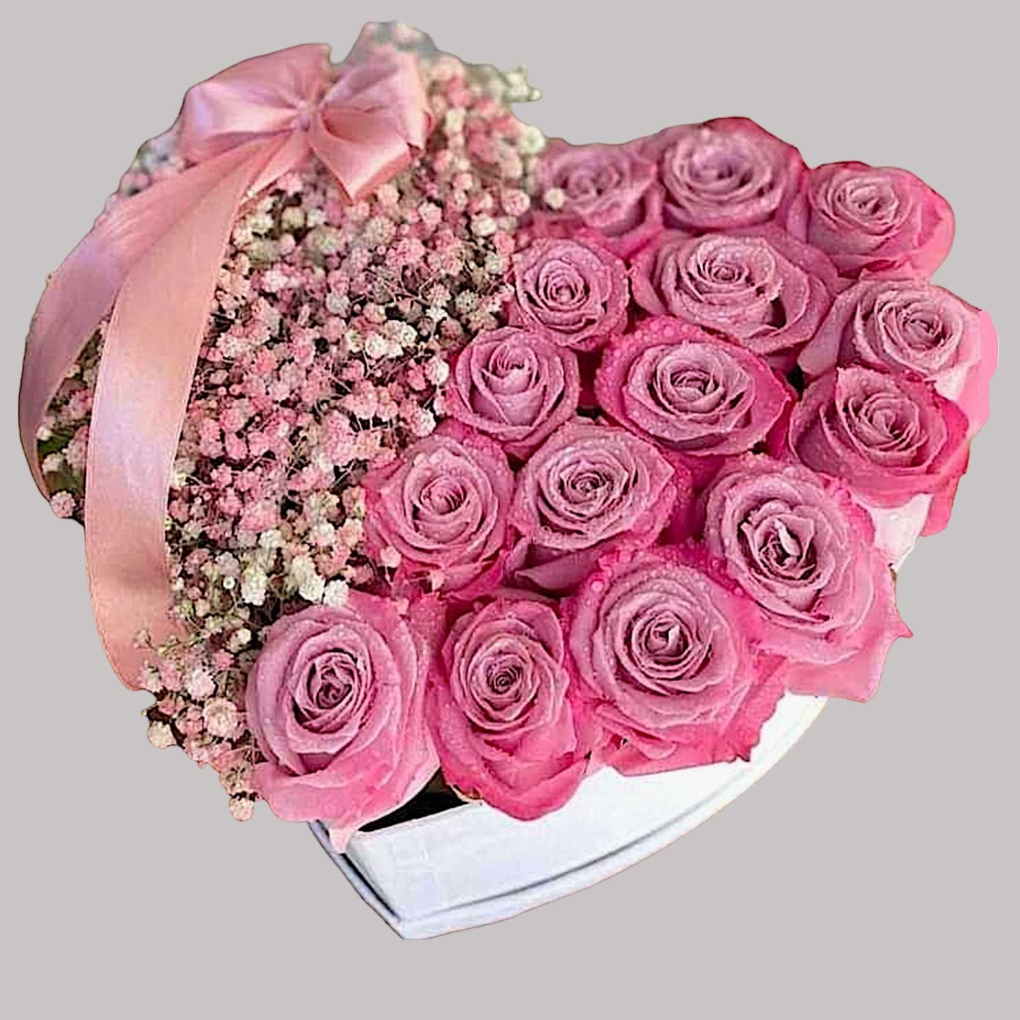 A modern flower arrangement in a heart box filled with roses and