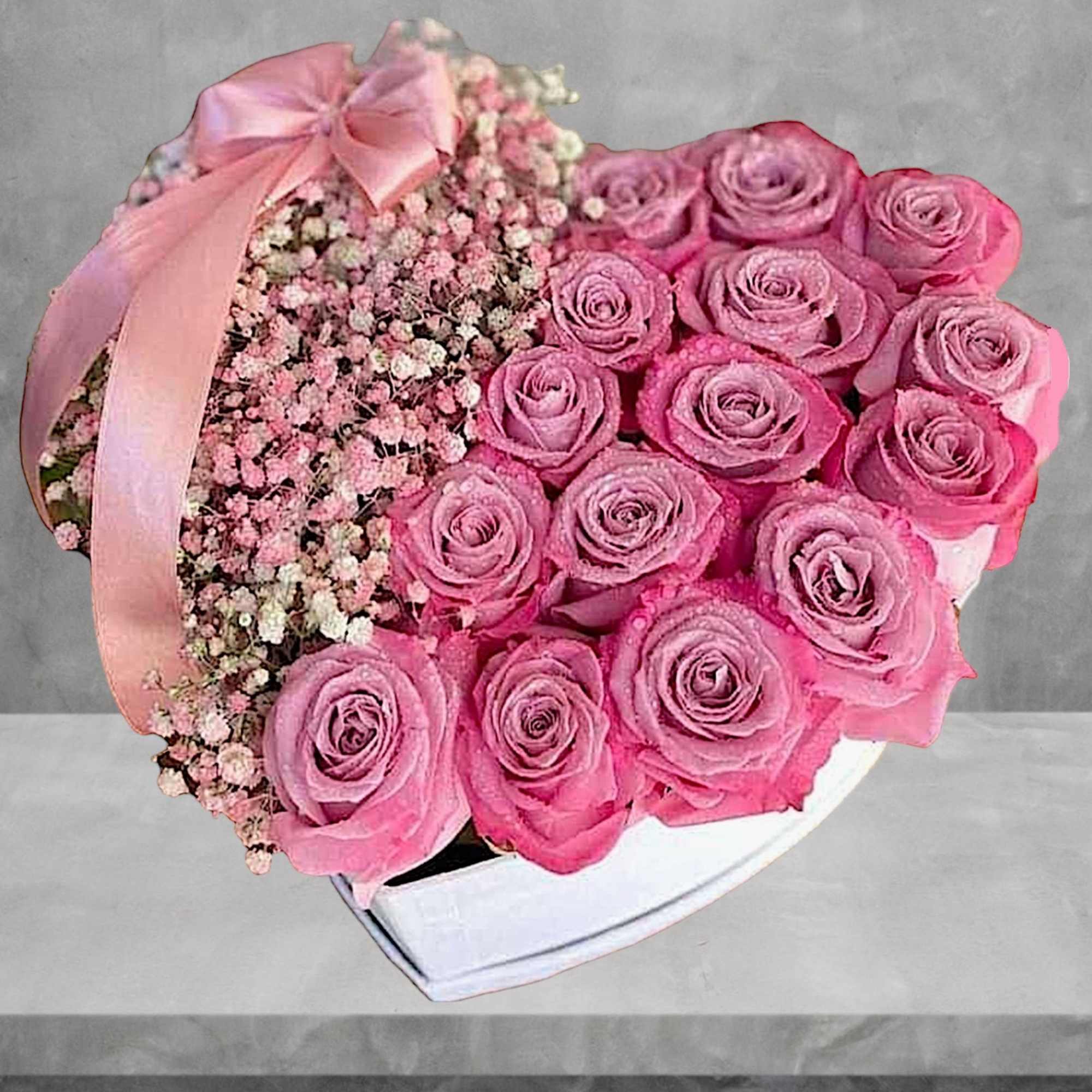 A modern flower arrangement in a heart box filled with roses and