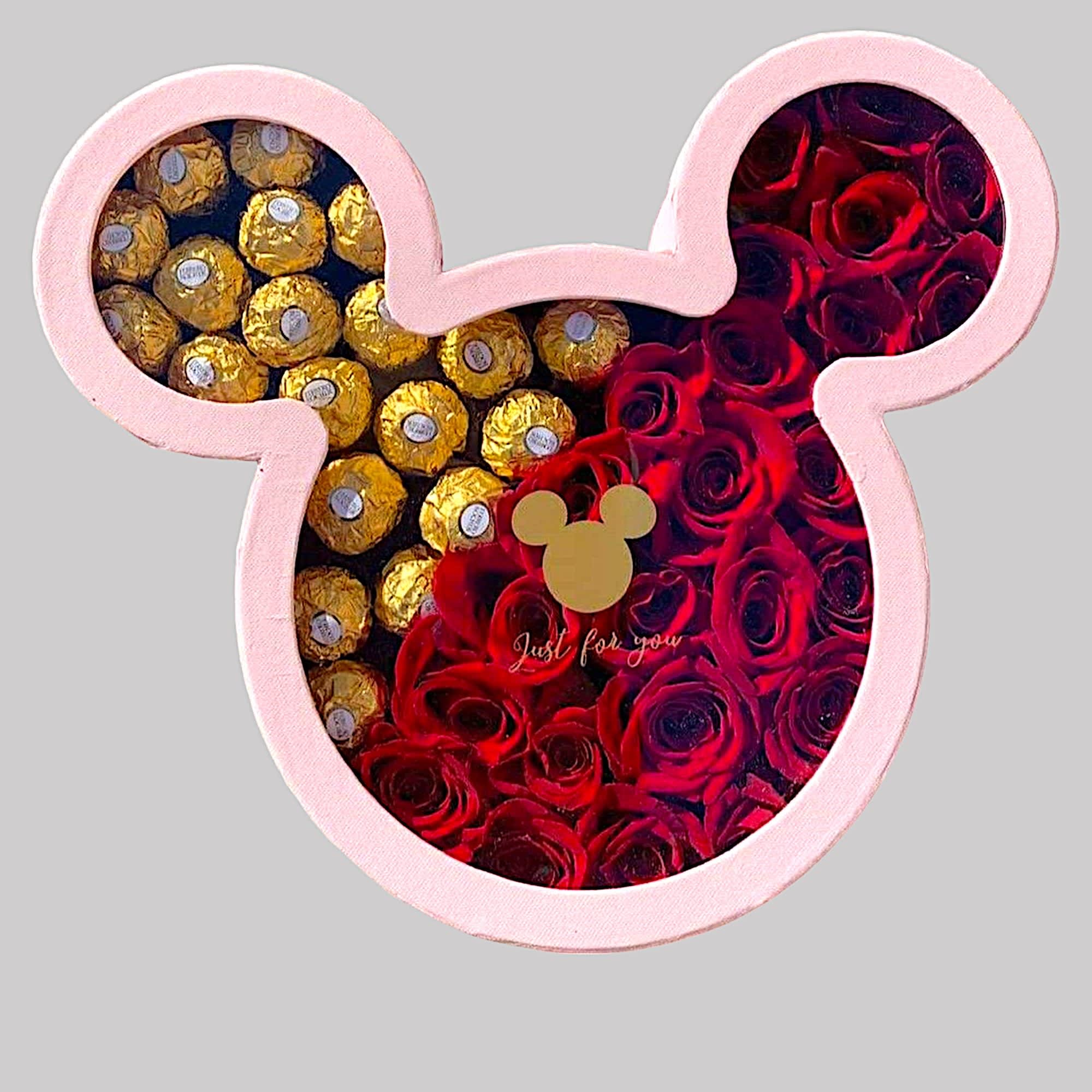 A modern flower arrangement in a mickey box filled with roses &amp;
