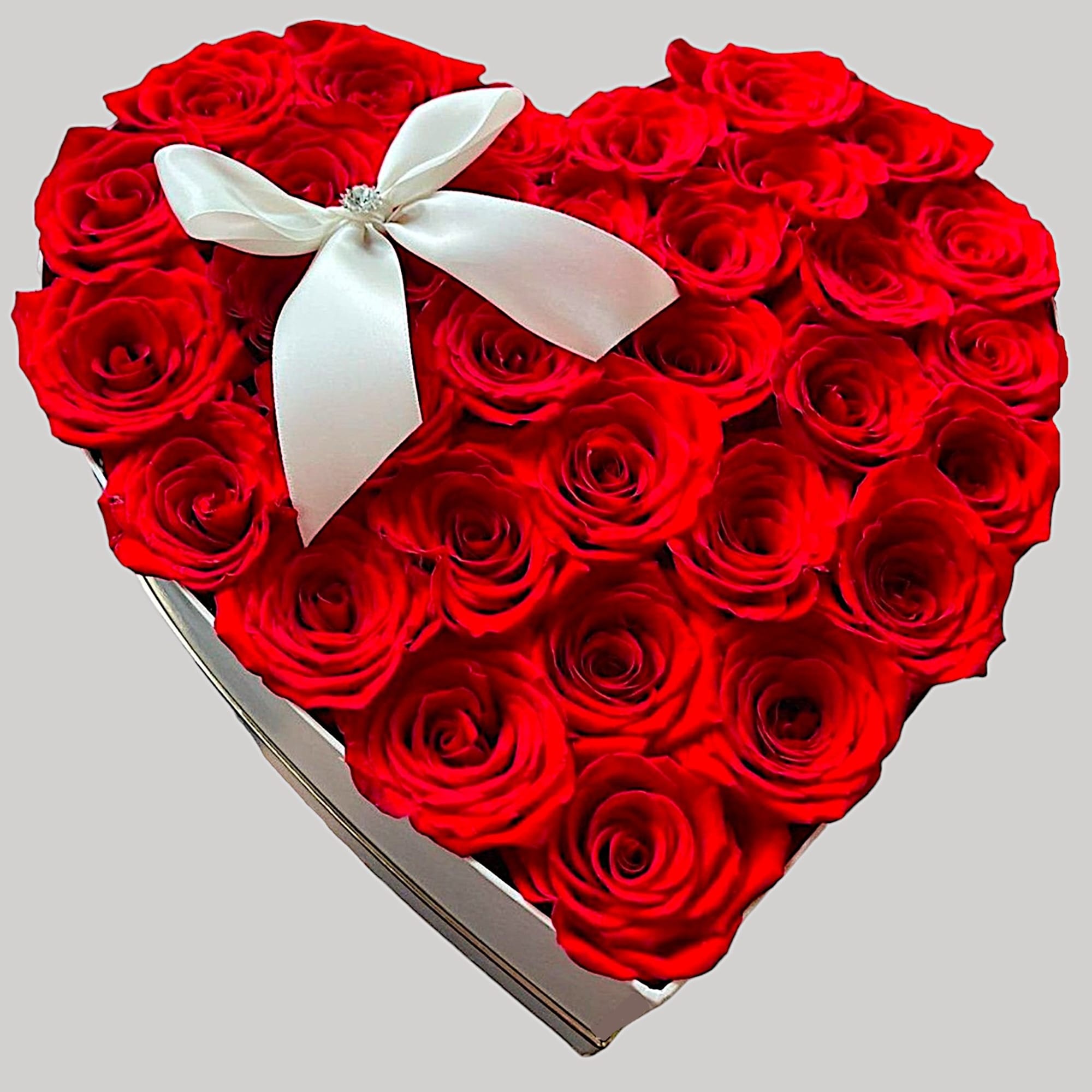 A modern flower arrangement in a heart box filled with roses.

DETAILS
This heart