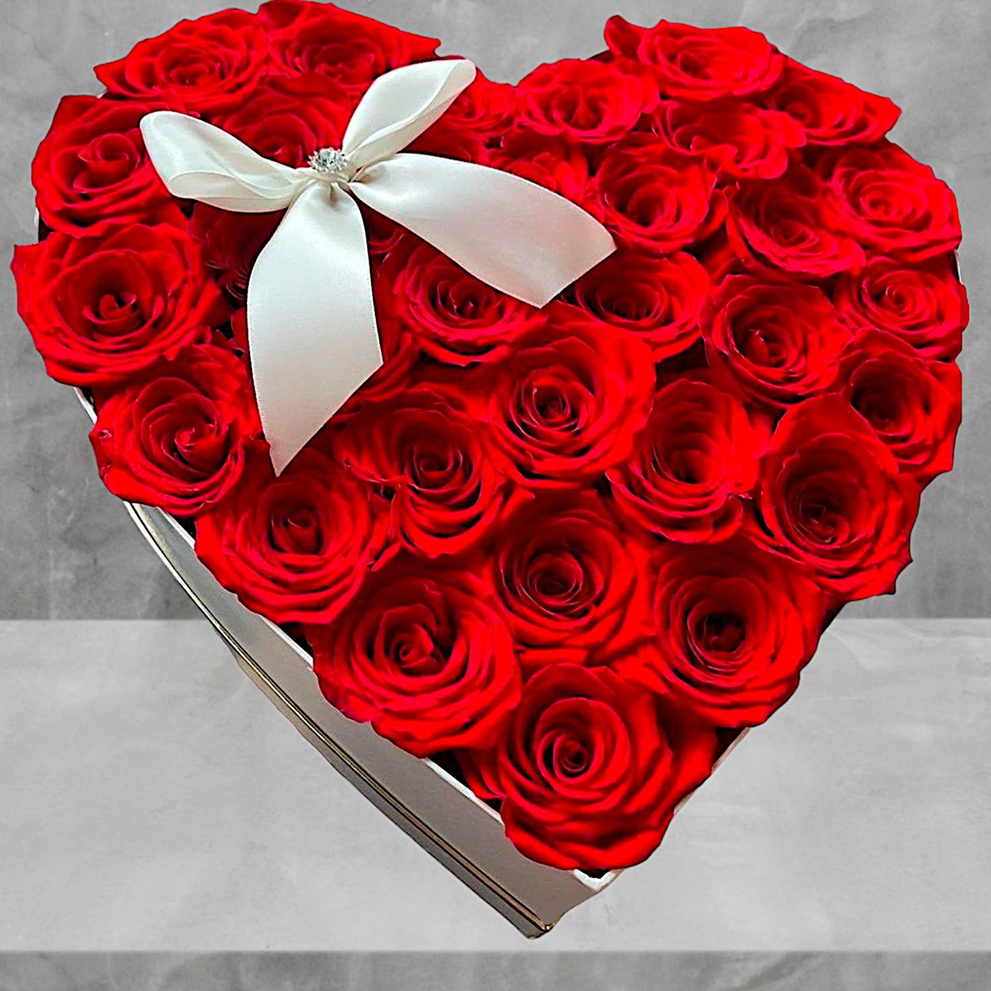 A modern flower arrangement in a heart box filled with roses.

DETAILS
This heart