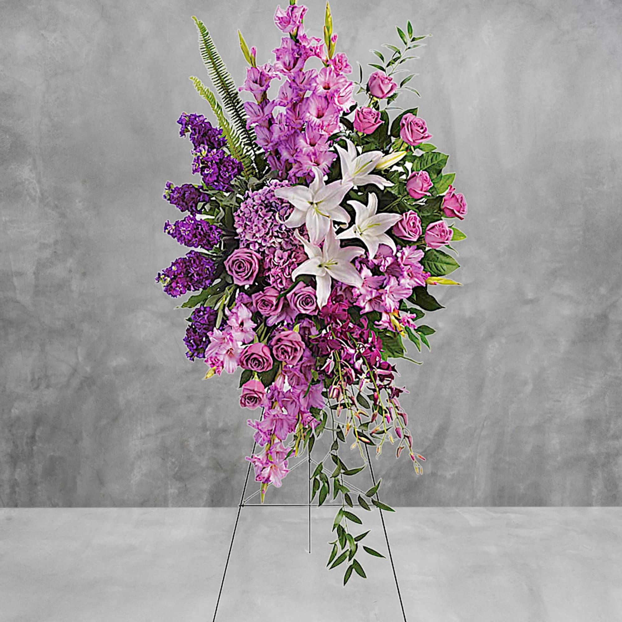 Blessed, peaceful rest is expressed in this cascading purple spray accented with