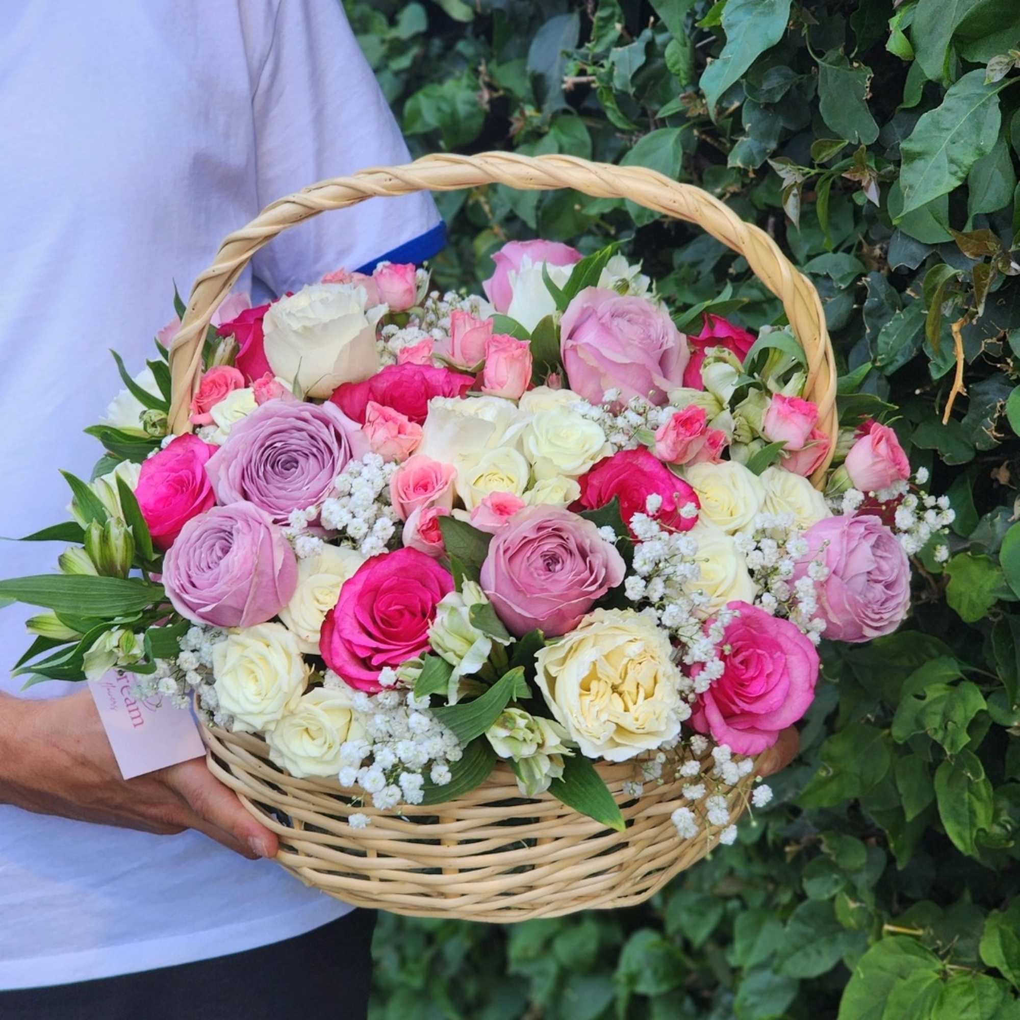 Vibrant hot pink, white roses, and purple roses gracefully arranged in a