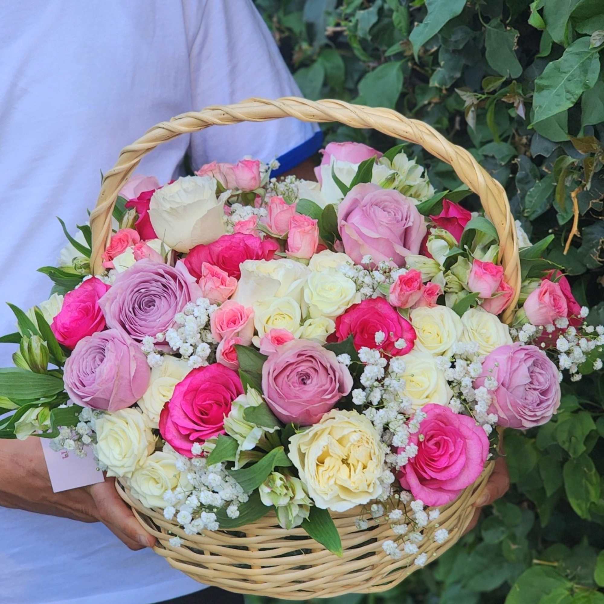 Vibrant hot pink, white roses, and purple roses gracefully arranged in a