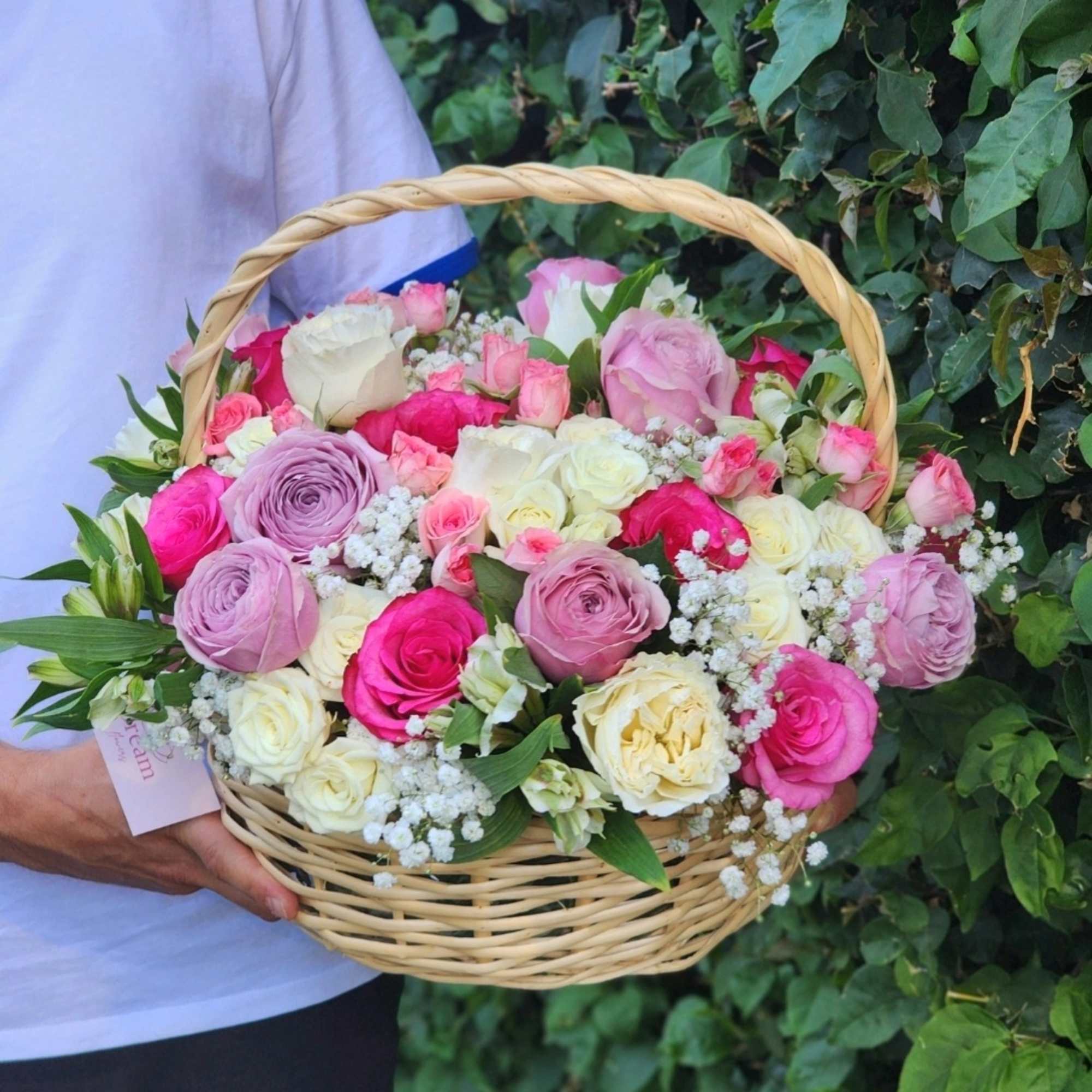 Vibrant hot pink, white roses, and purple roses gracefully arranged in a