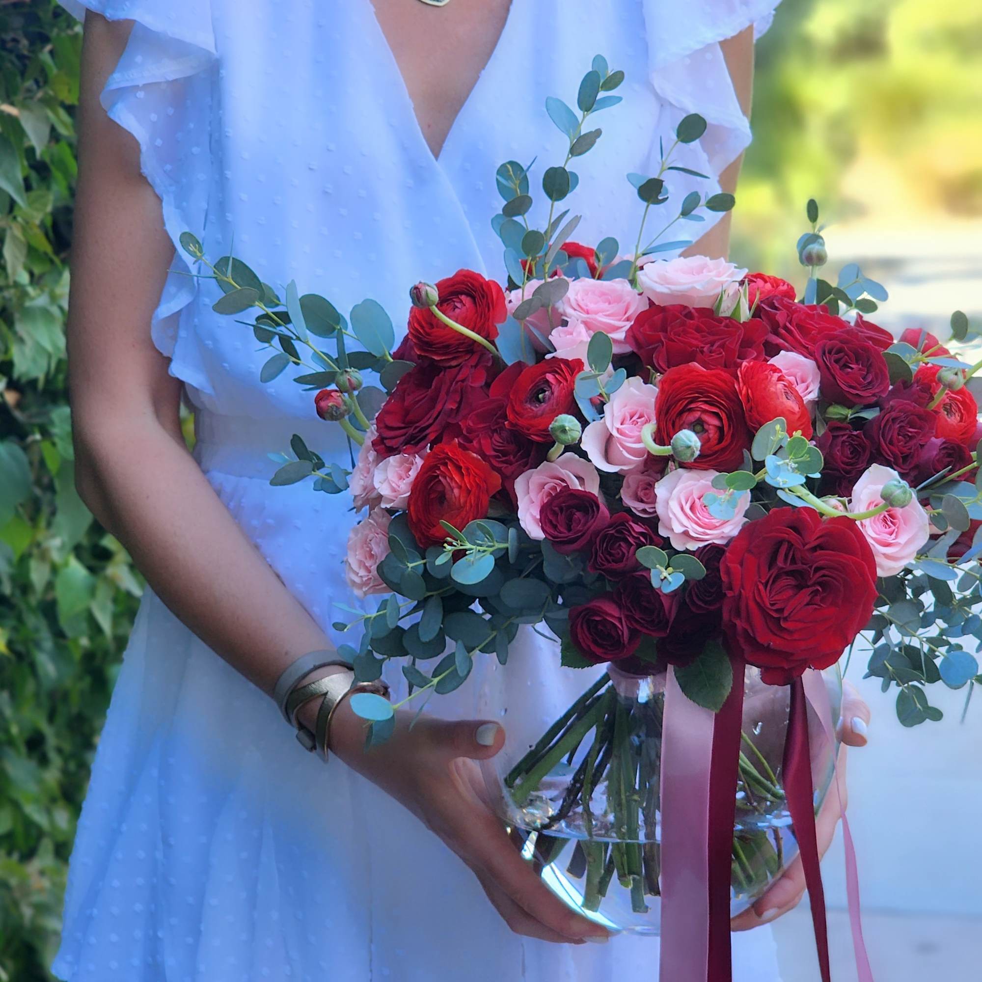 Discover stunning arrangements with red roses, vibrant ranunculus, pink spray roses, and