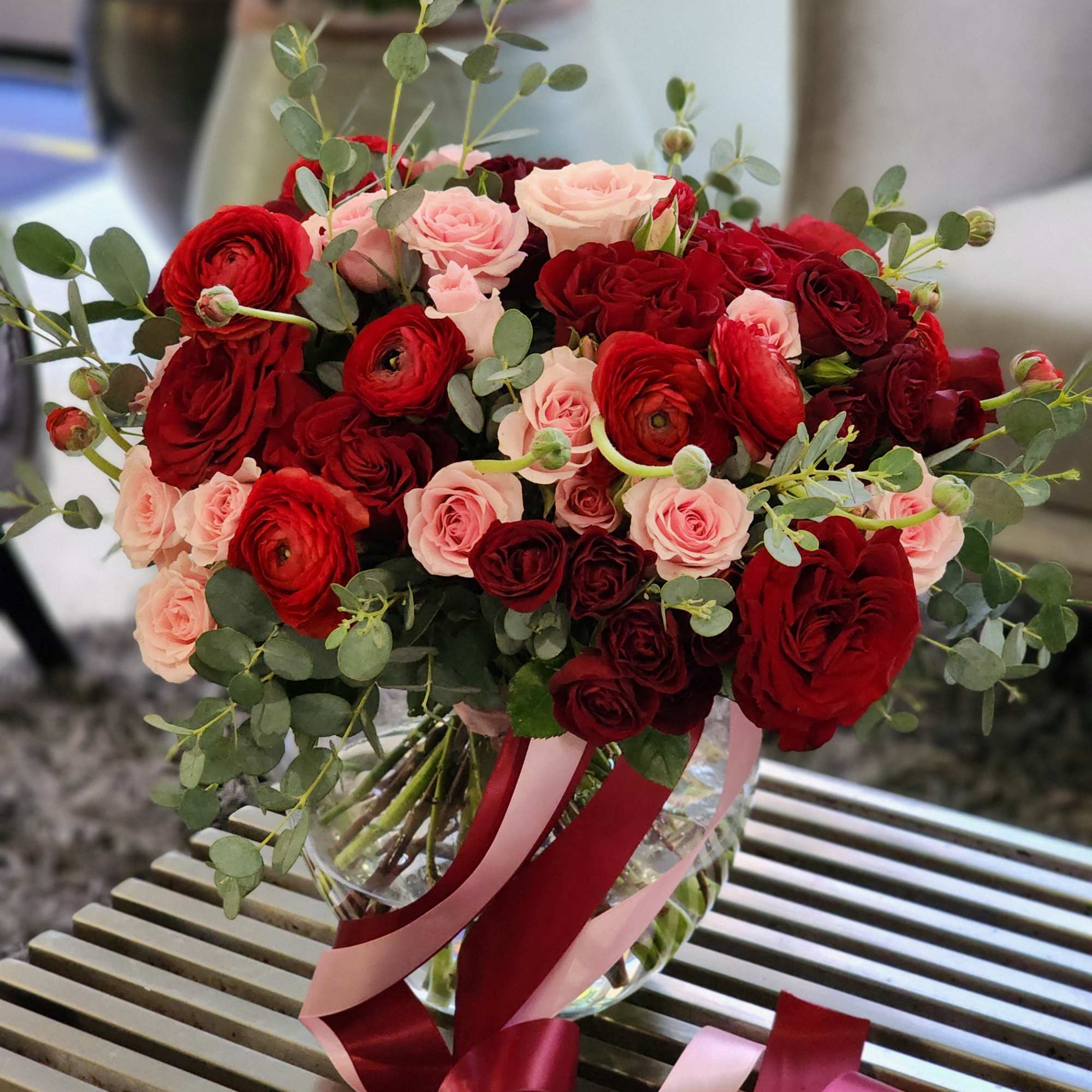 Discover stunning arrangements with red roses, vibrant ranunculus, pink spray roses, and