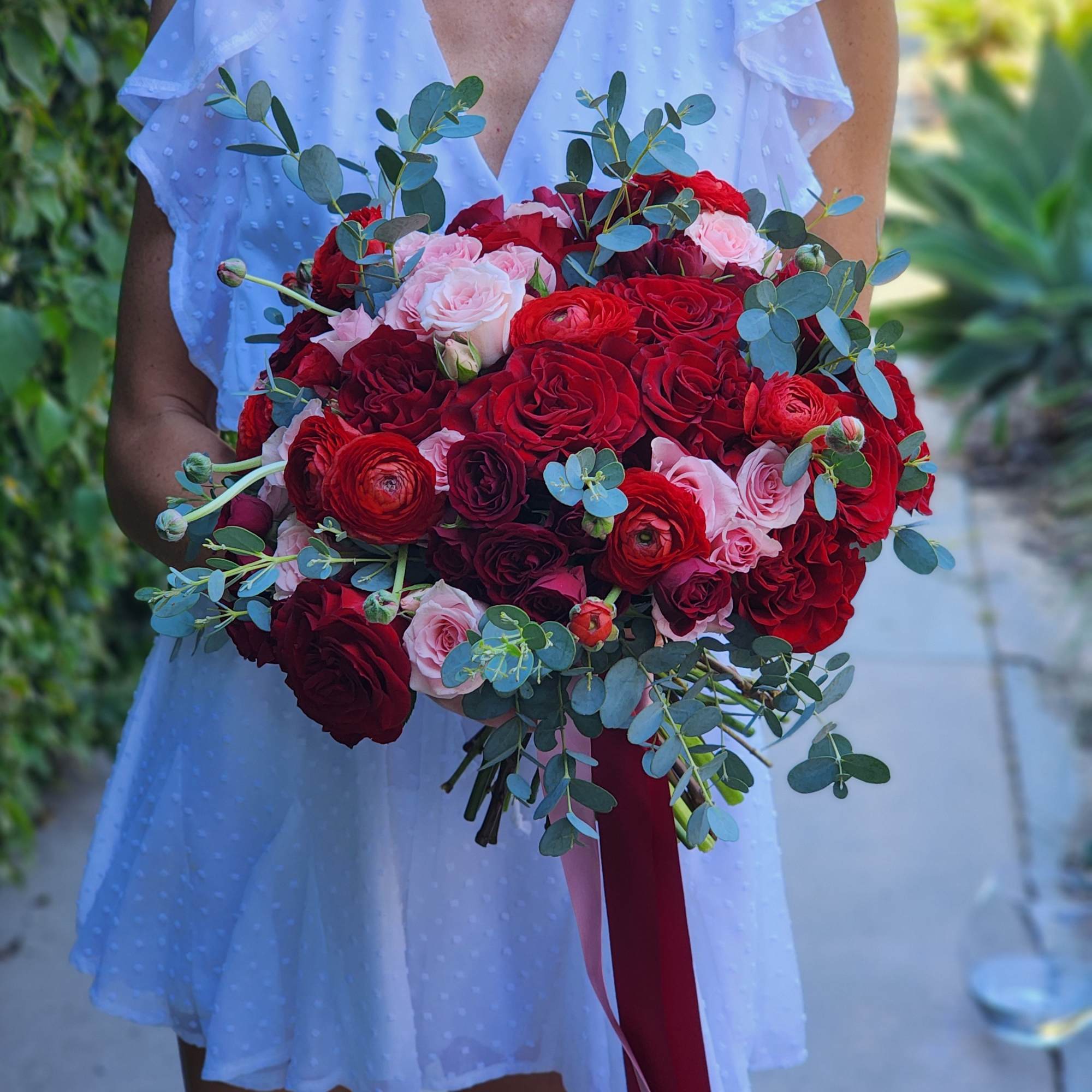 Discover stunning arrangements with red roses, vibrant ranunculus, pink spray roses, and