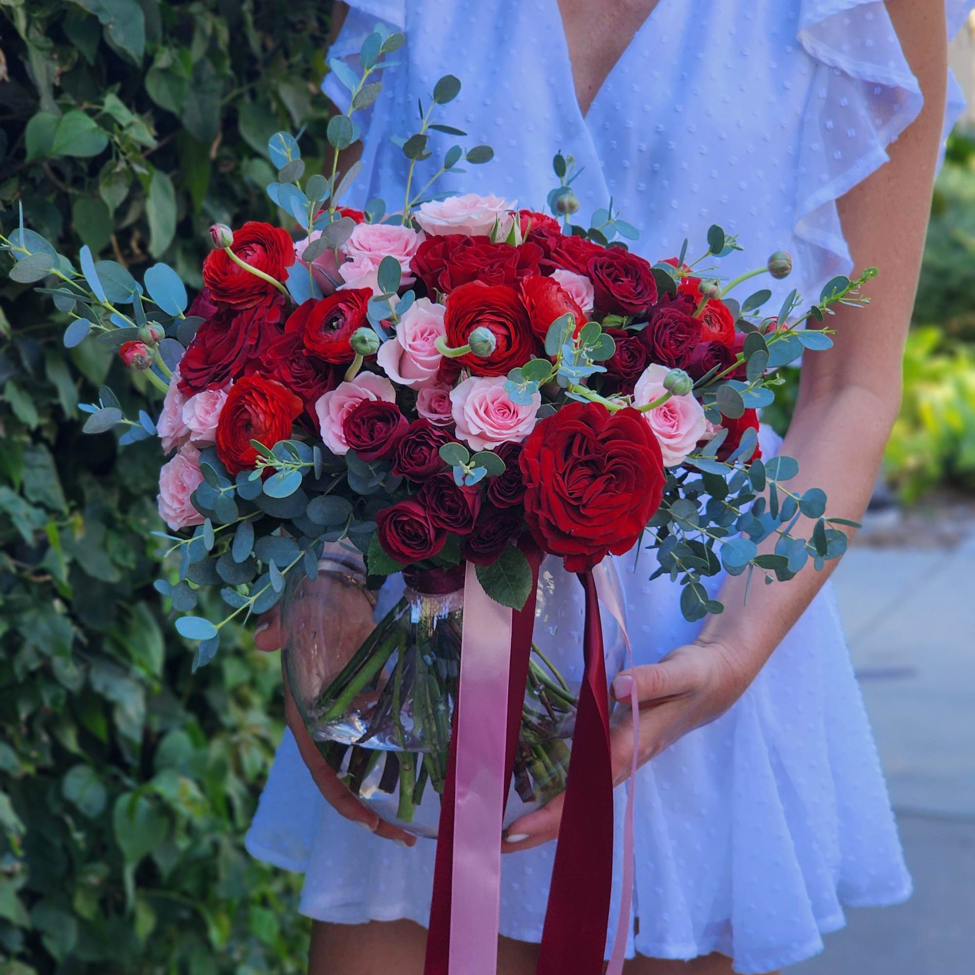Discover stunning arrangements with red roses, vibrant ranunculus, pink spray roses, and