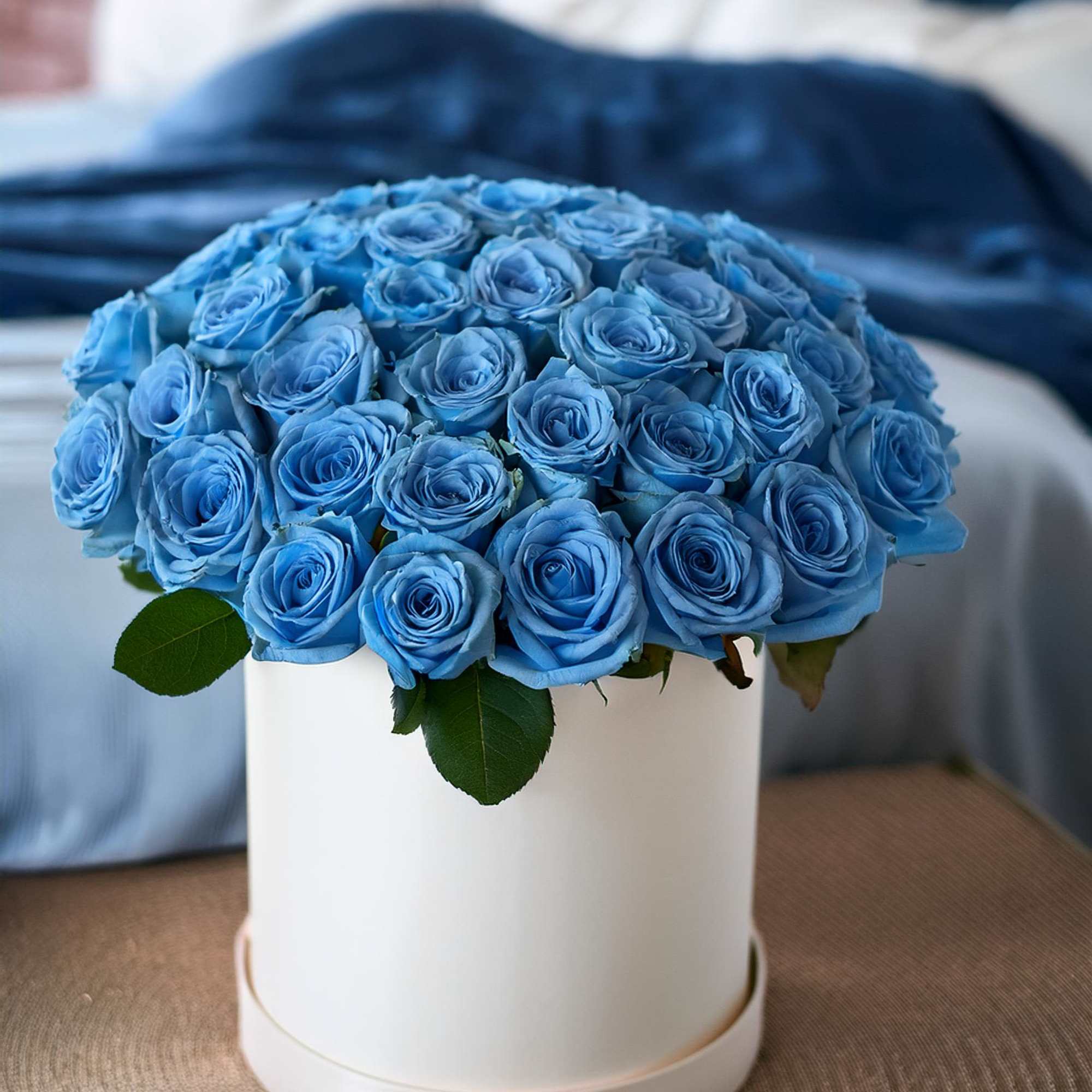 Stunning beauty of blue sky roses in a chic hatbox. This vibrant