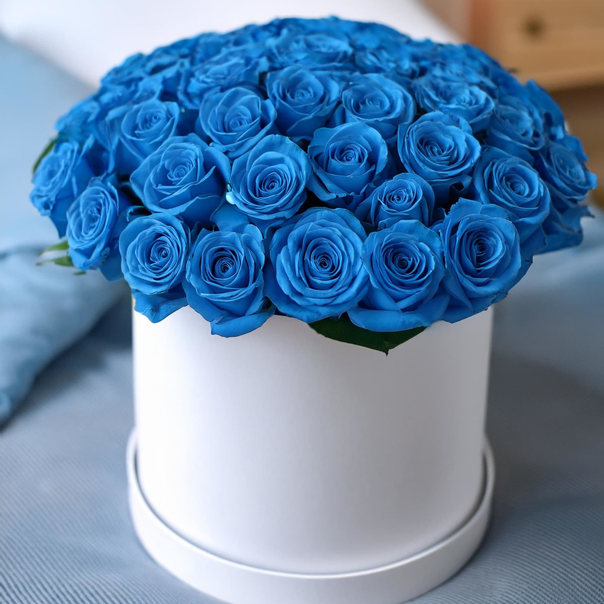 Stunning beauty of blue sky roses in a chic hatbox. This vibrant