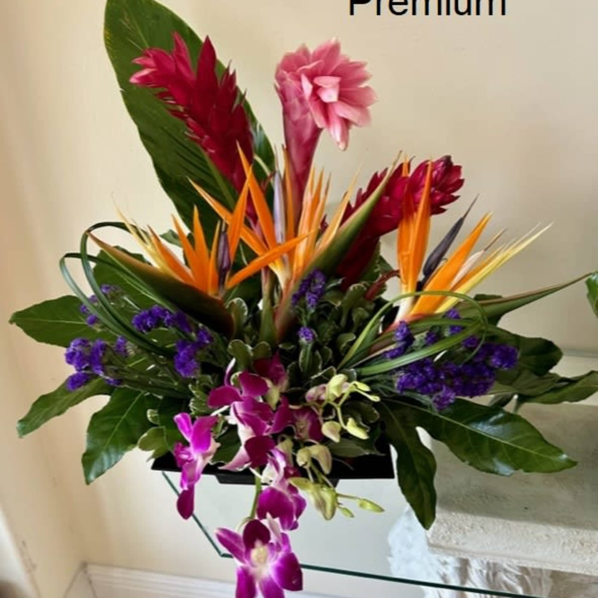 Tropical Flowers as shown arranged in a vase. Deluxe version shows more