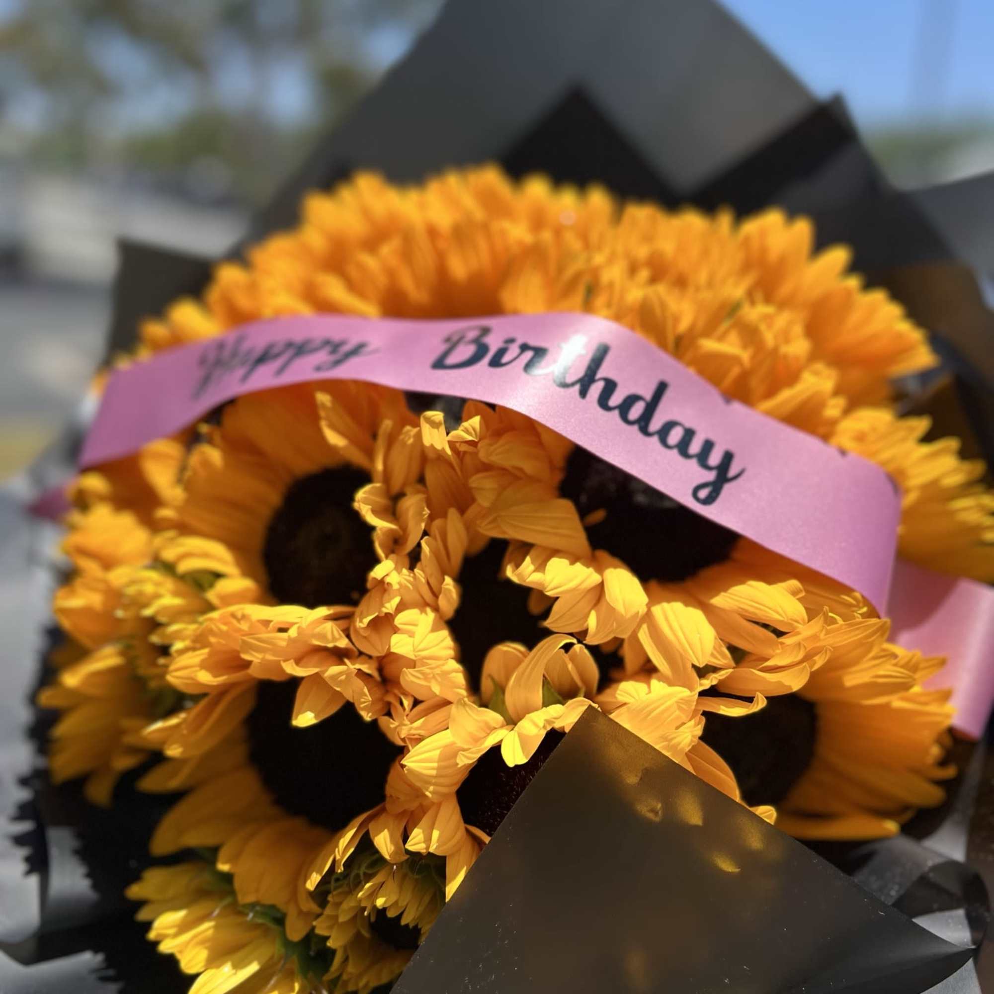 Bouquet of 25 sunflowers with a custome message on the ribbon.