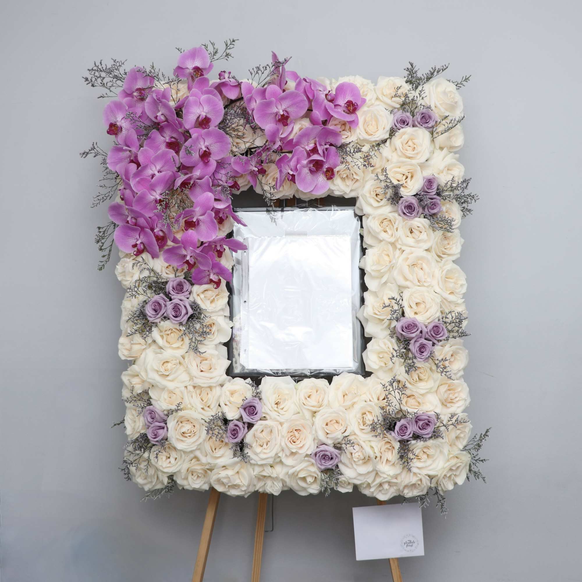 This sympathy frame is made with white florals with lavender accents. It This sympathy frame is made with white florals with lavender accents. It