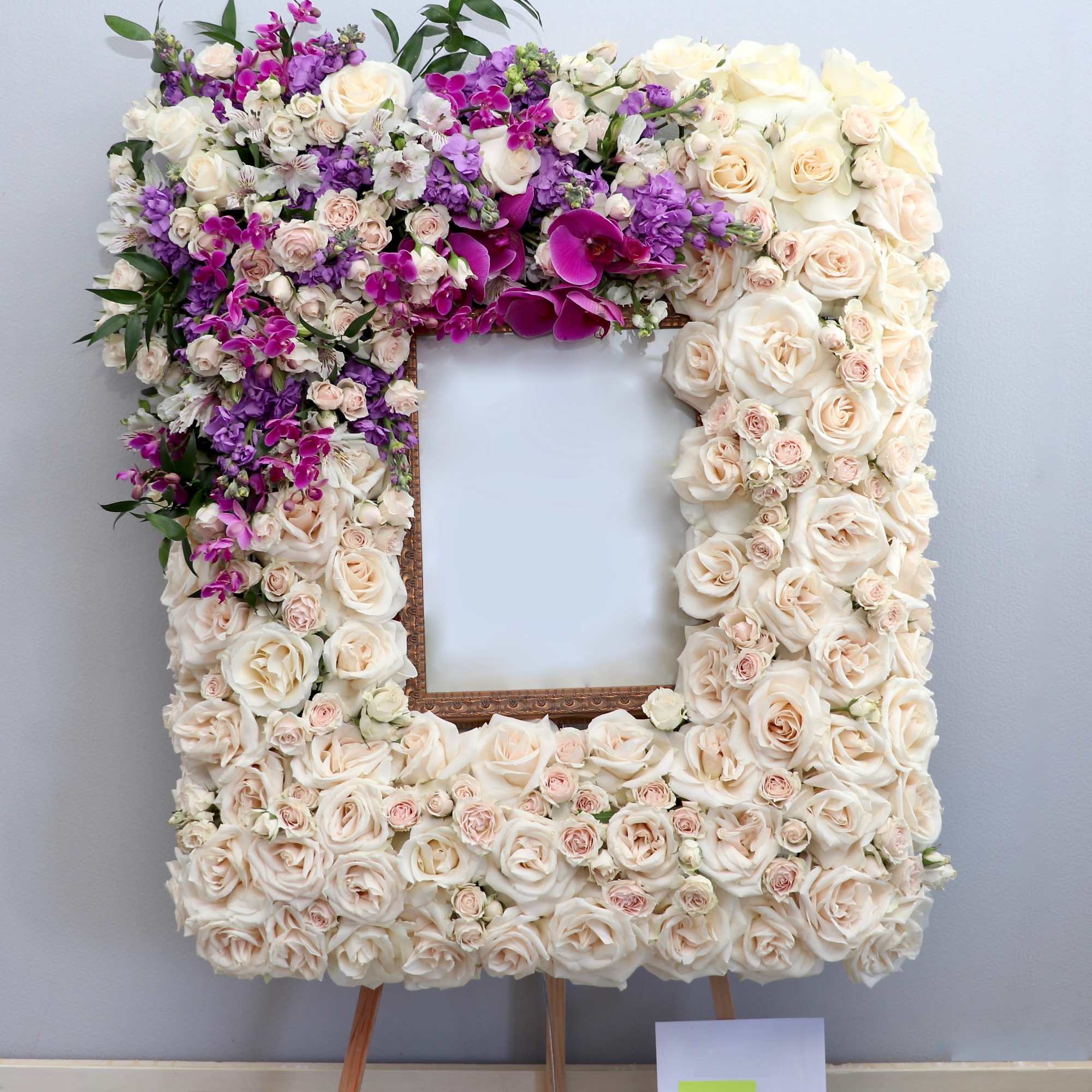 This frame includes roses and seasonal lavender and purples florals. The standard