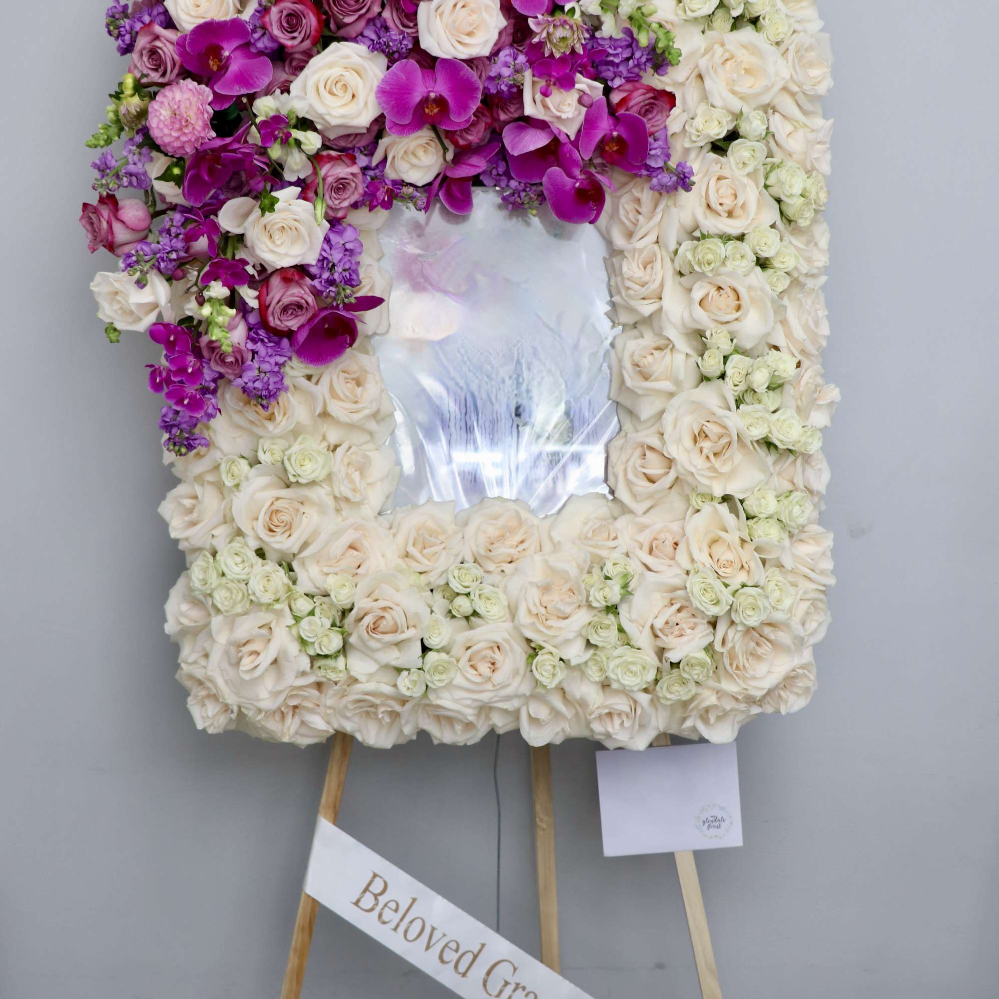 This frame includes roses and seasonal lavender and purples florals. The standard