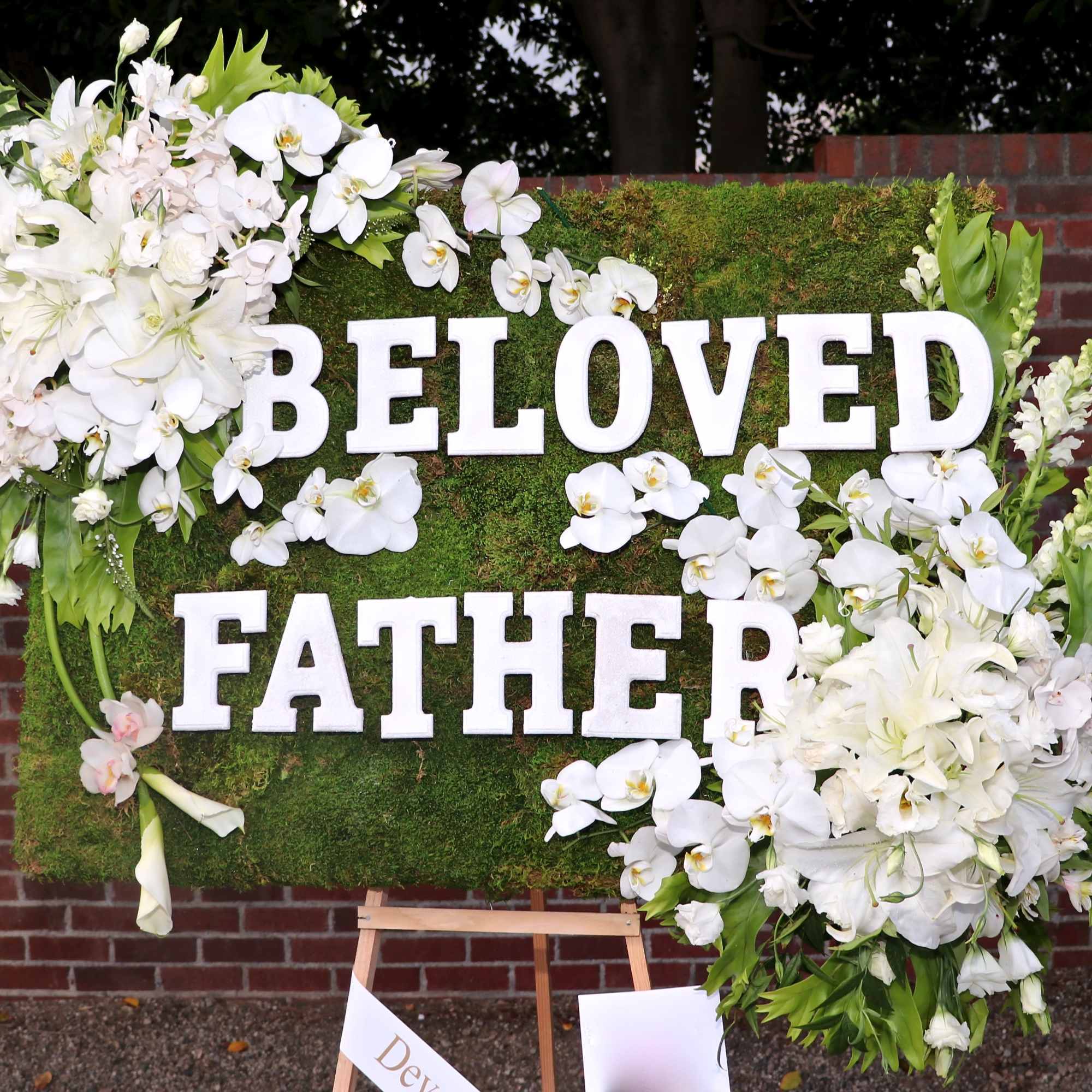Covered in moss, this frame includes orchids, tulips, and season flowers. It