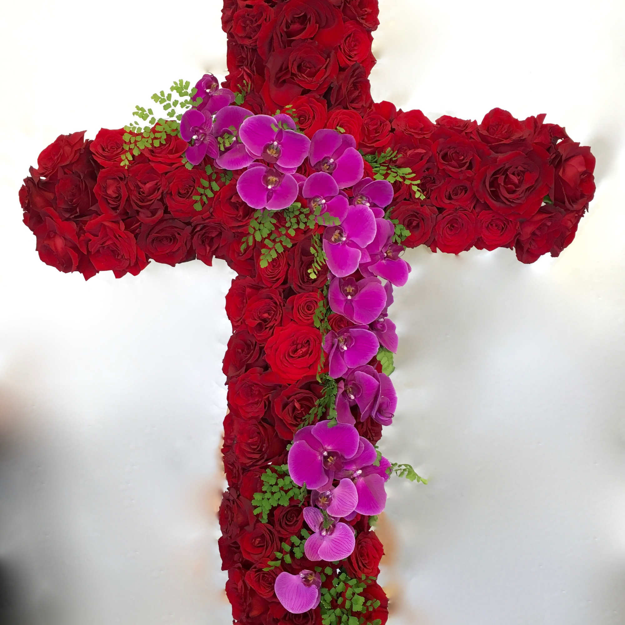 This large arrangement features a classic combination of roses and orchids. 

We