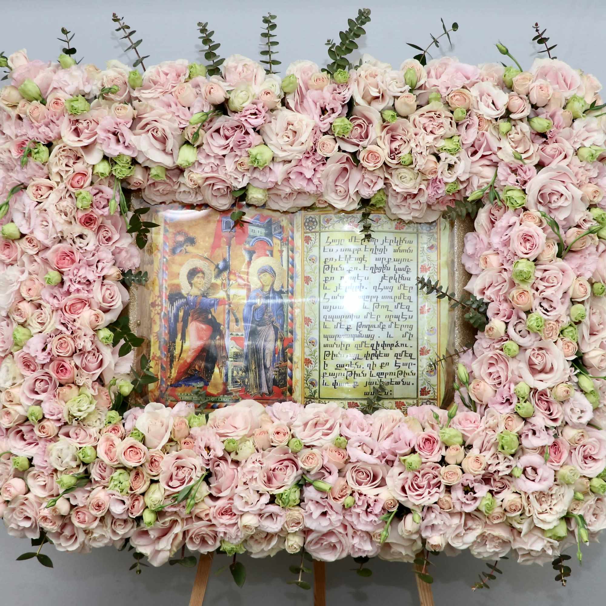 This frame includes pink roses and seasonal greenery. The standard size is