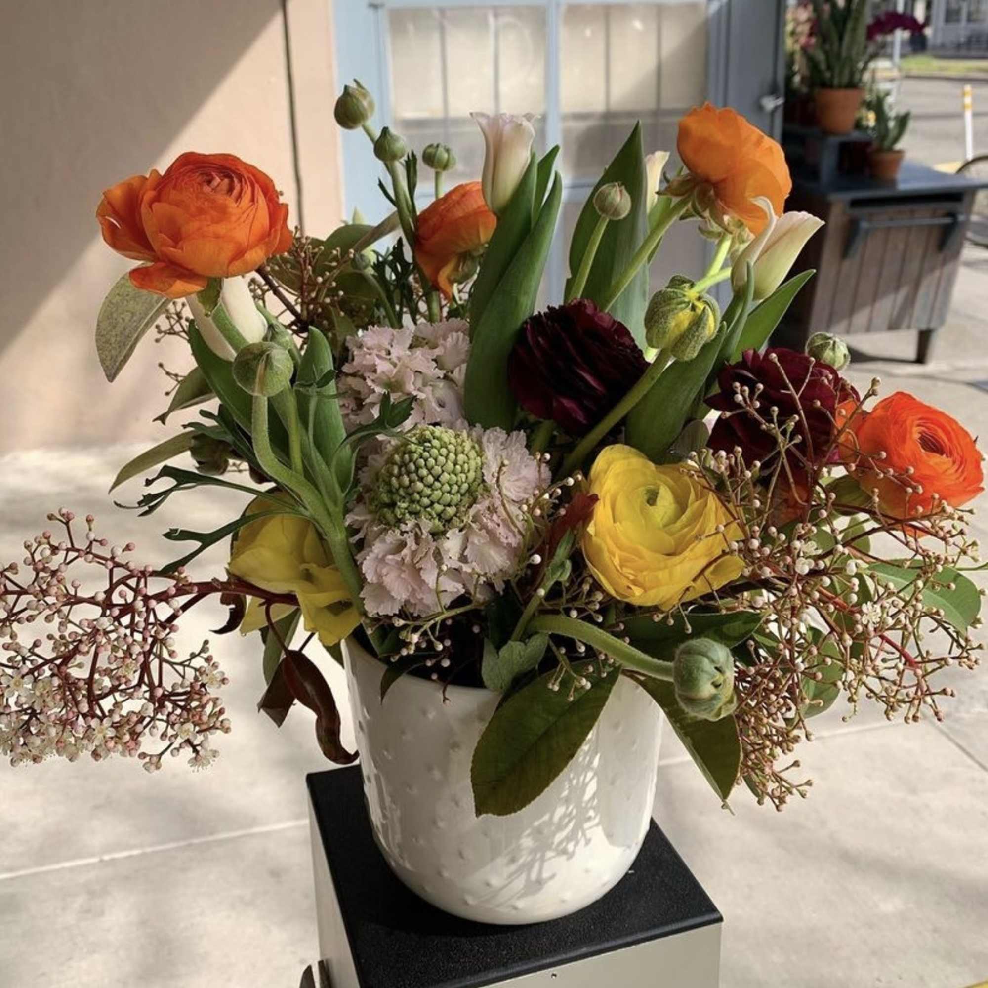 The sweetest table top arrangement with tulips, ranunculus, scabiosa, and filler. 