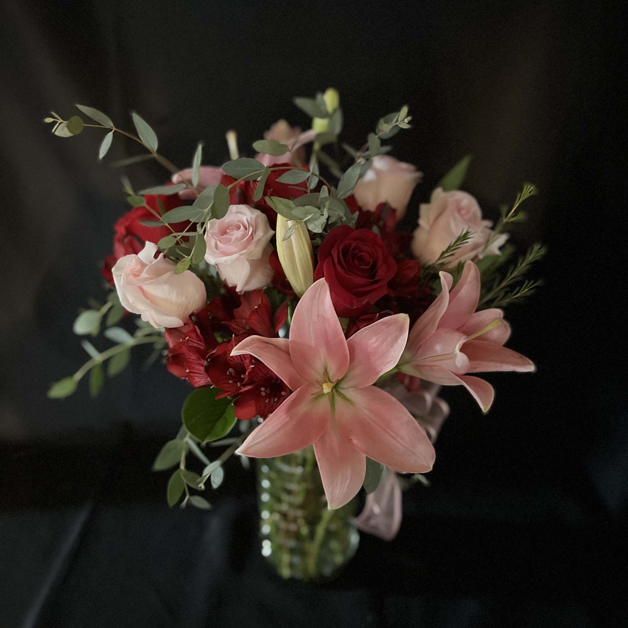 Red, pink, roses and lilies with beautiful green foliage. 

  