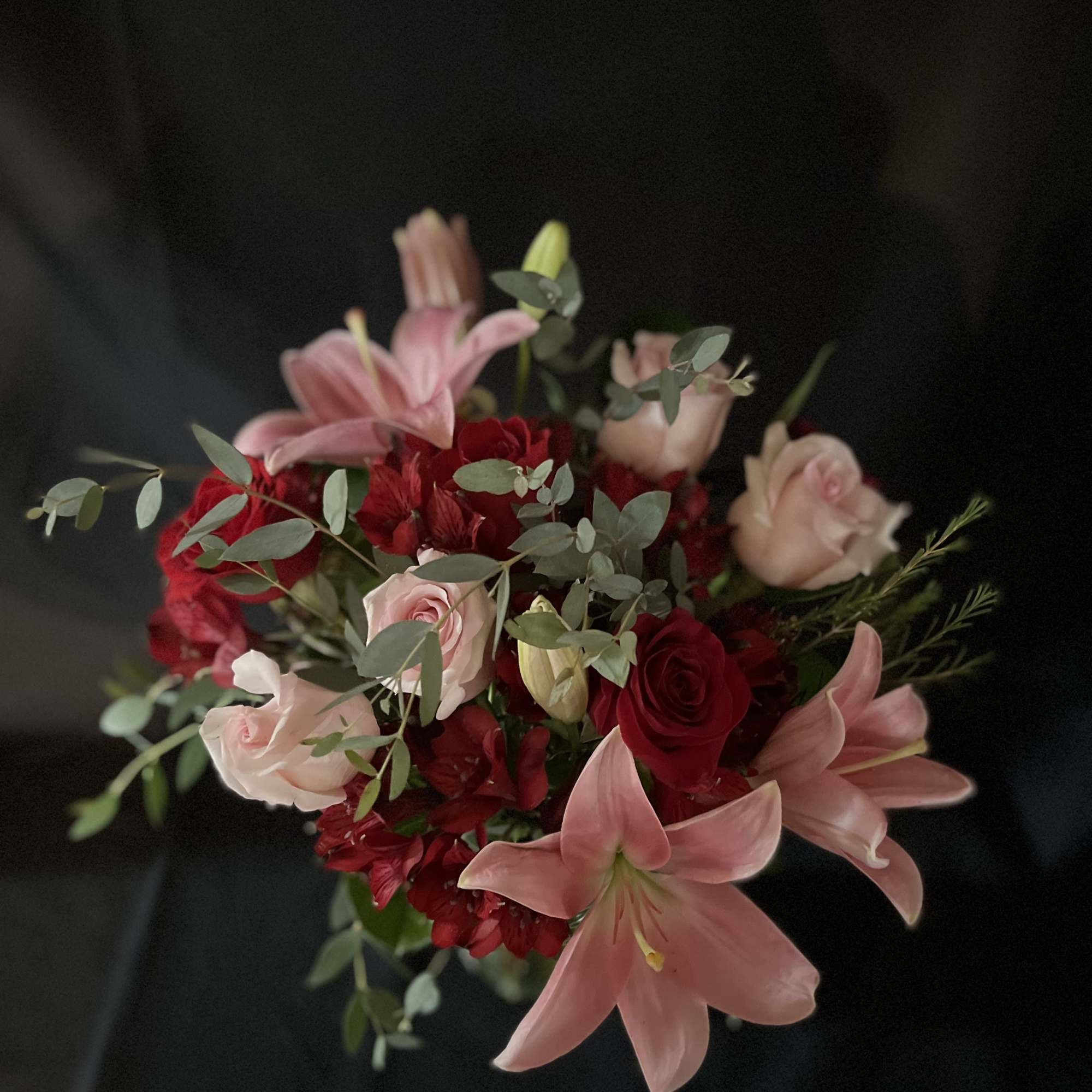 Red, pink, roses and lilies with beautiful green foliage. 

  