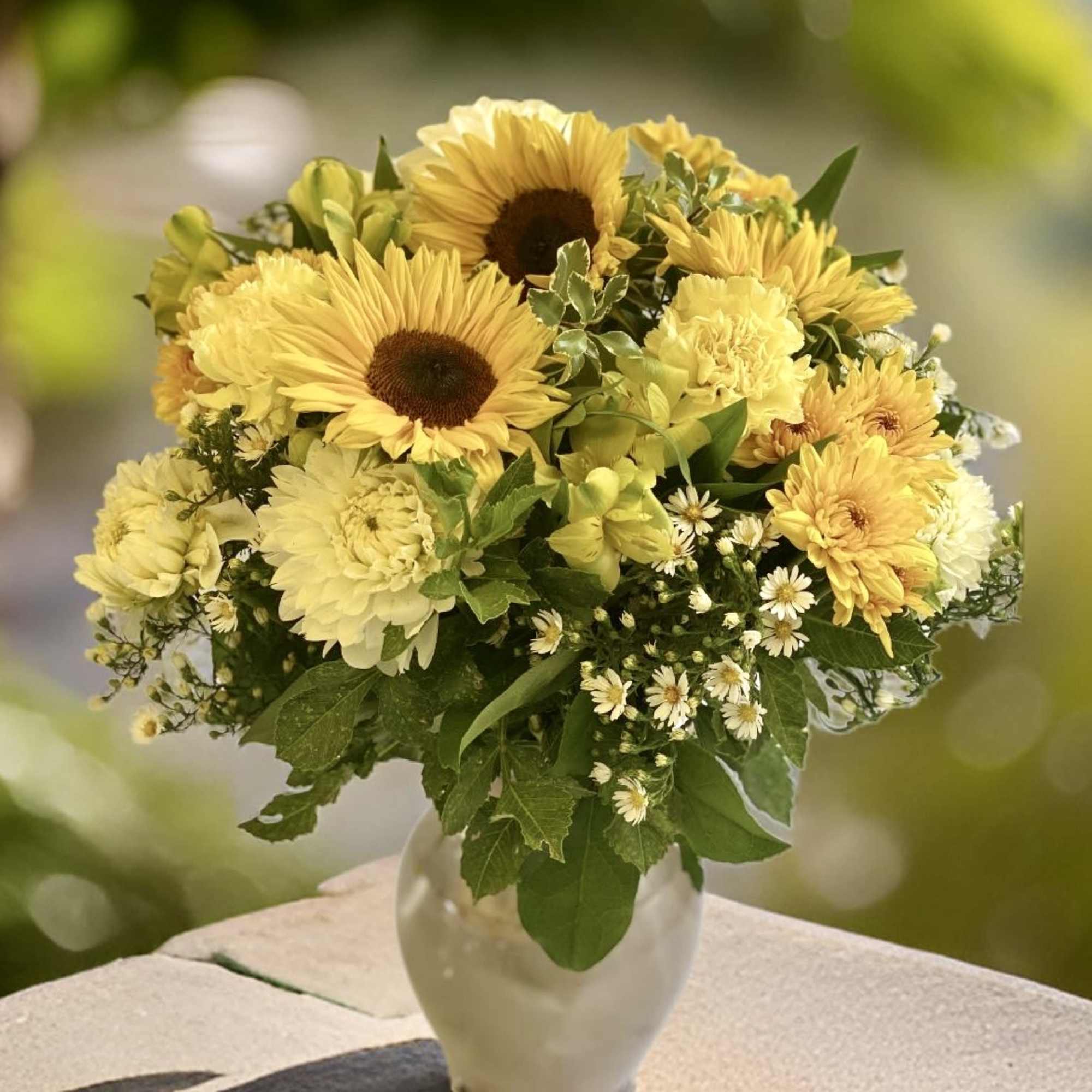 An artistic and bright yellow arrangement is a pleaser and interesting as