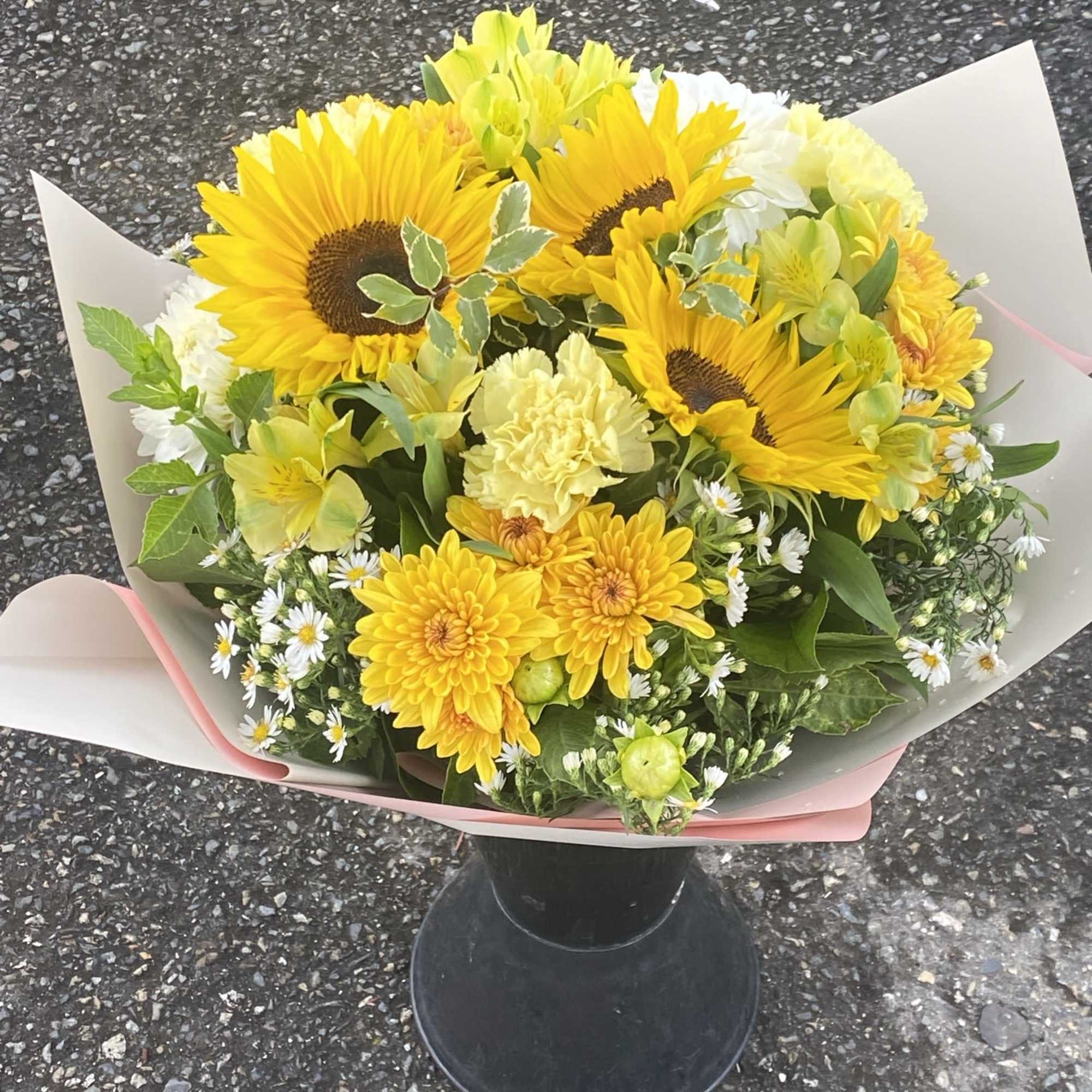 An artistic and bright yellow arrangement is a pleaser and interesting as