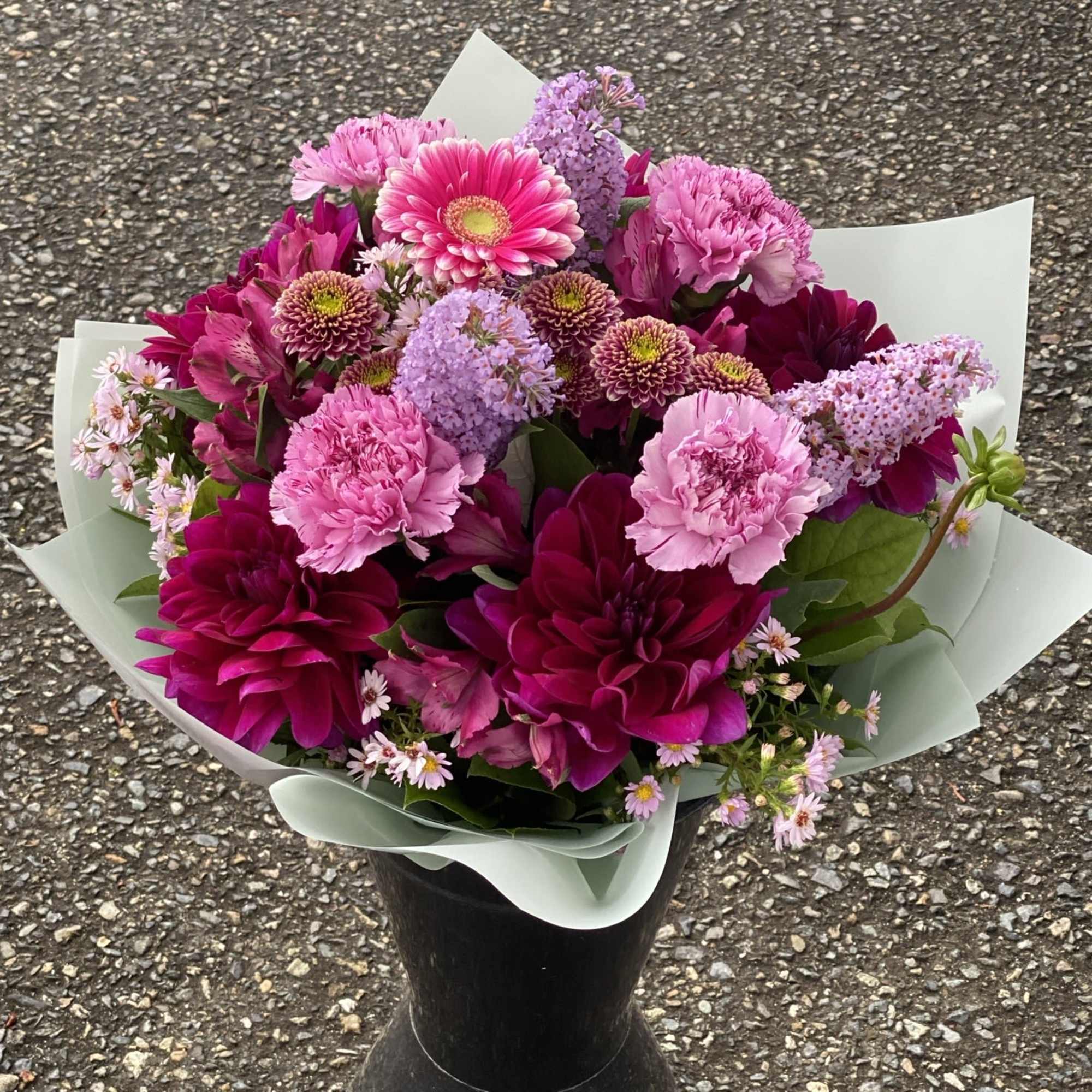 An artistic and colorful purple arrangement is a pleaser and interesting as