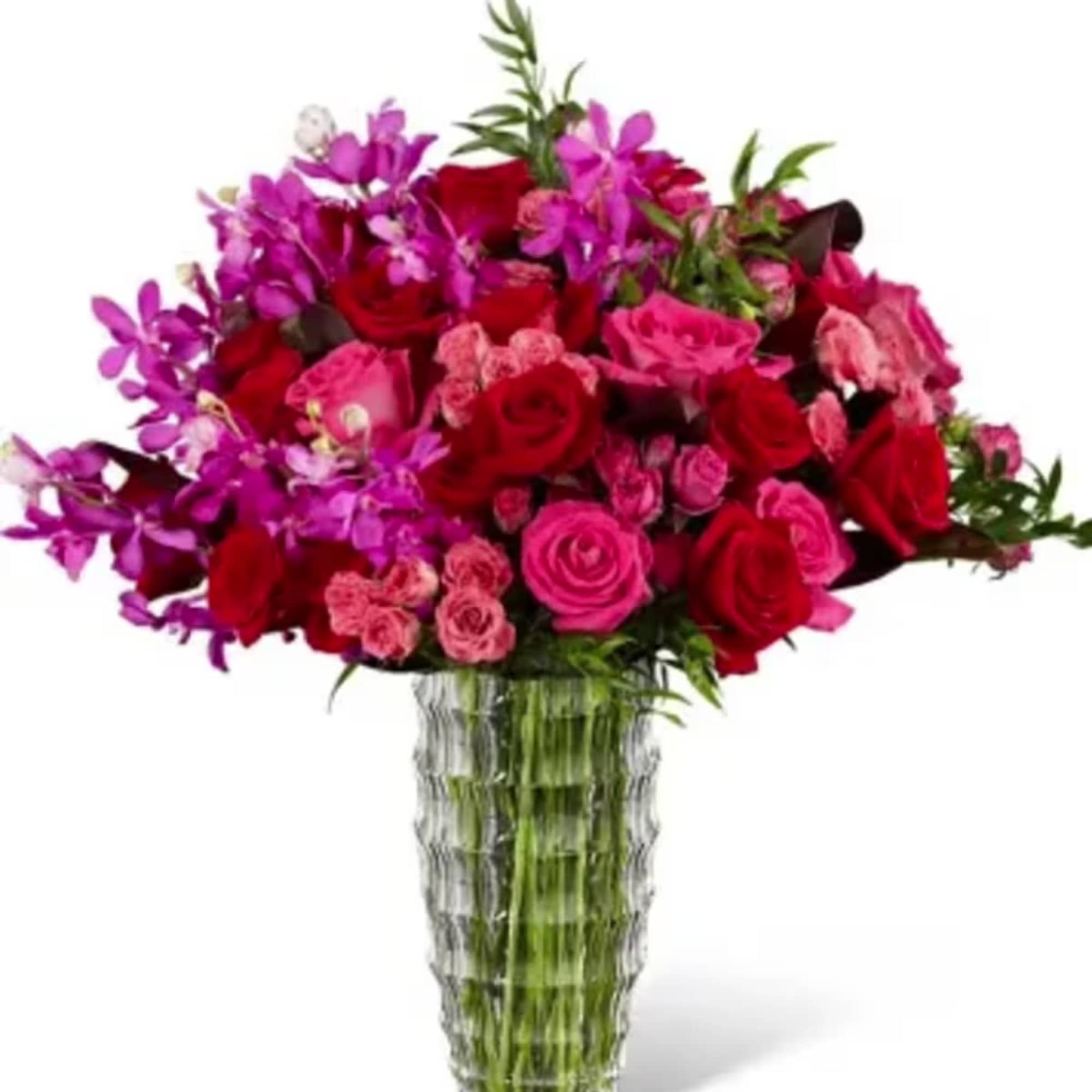 This vibrant arrangement of roses, tulips, and orchids is bursting with shades
