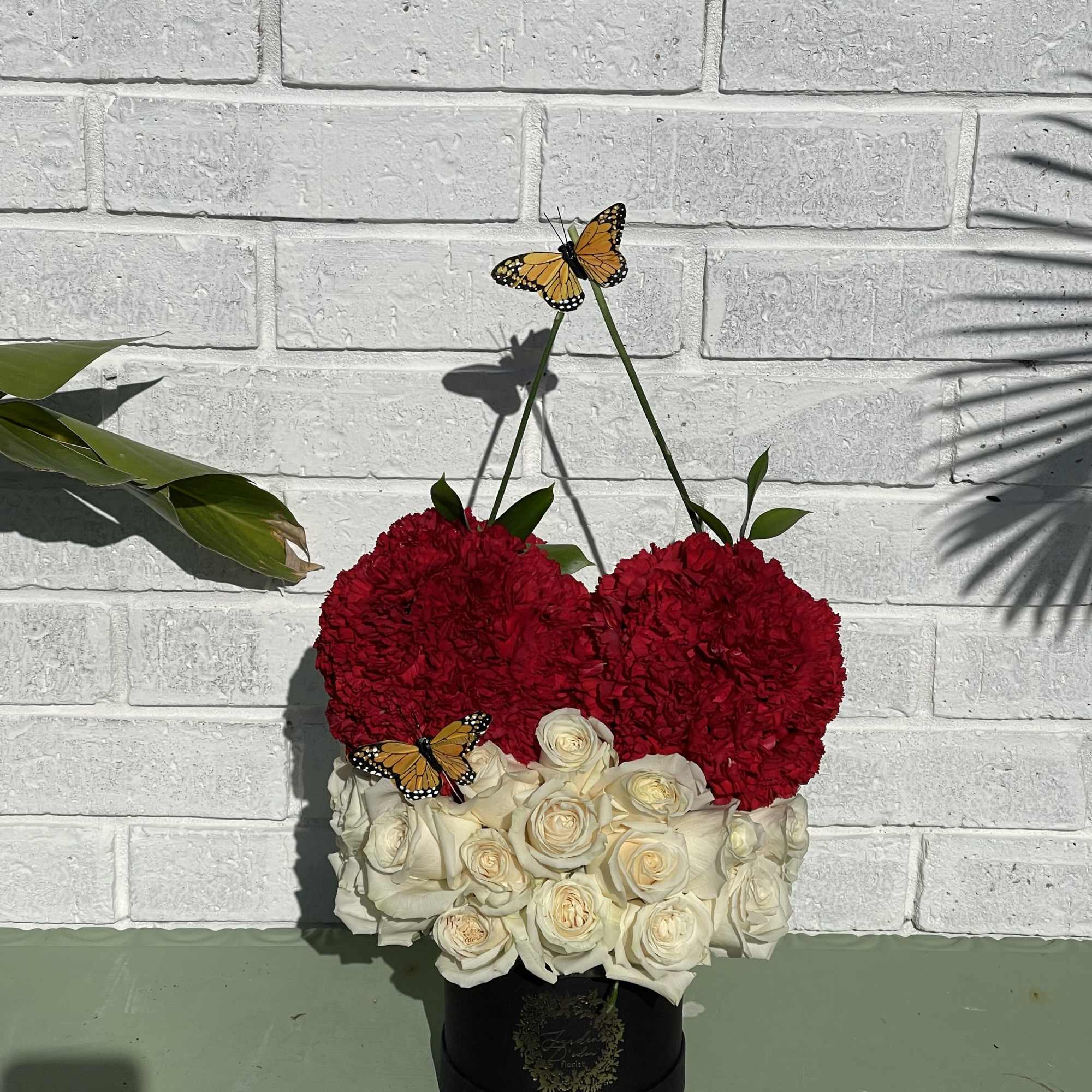 a beautiful white rose bloom box with 2 cherries created with red