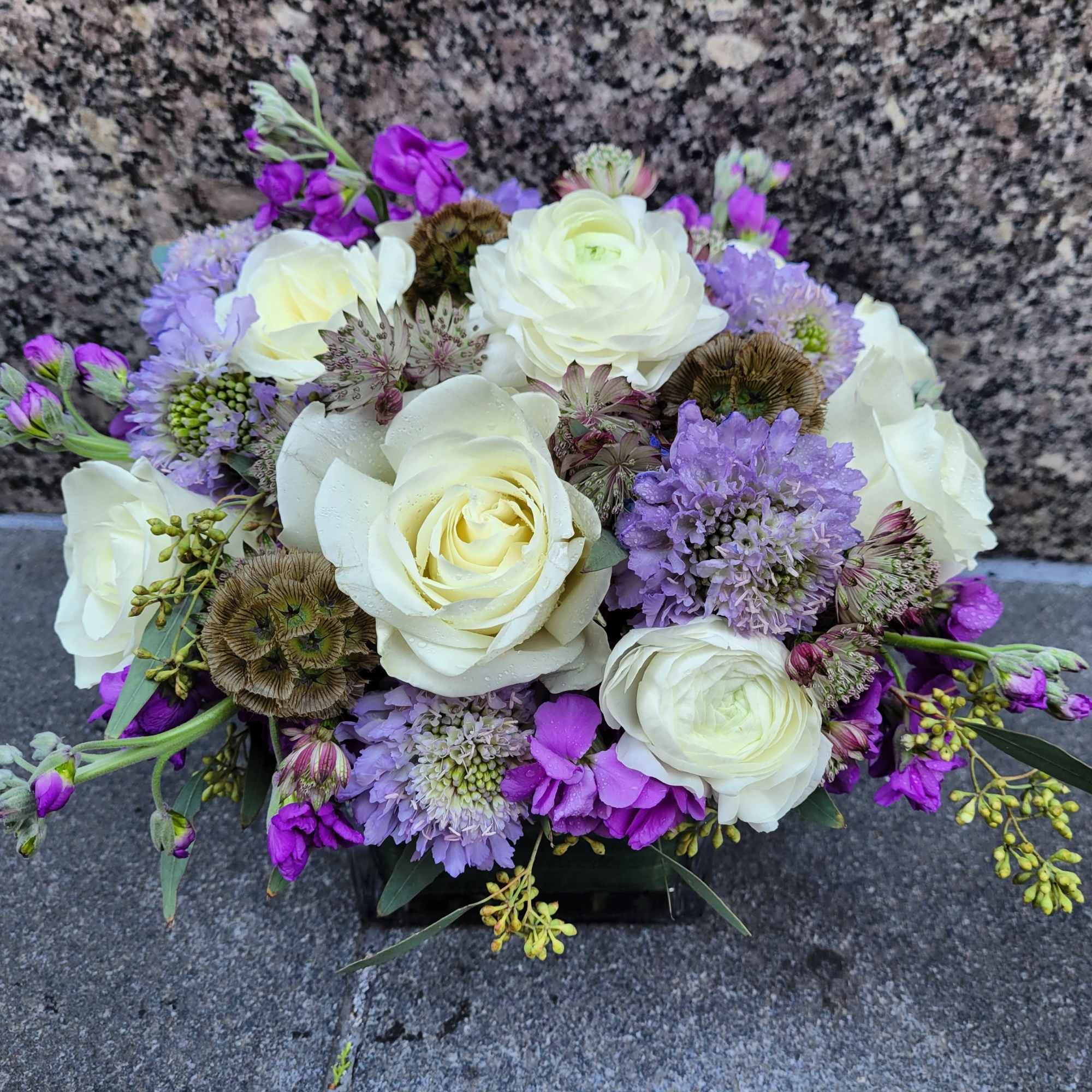 Introducing our Lavender Mist Floral Arrangement, where the timeless beauty of white