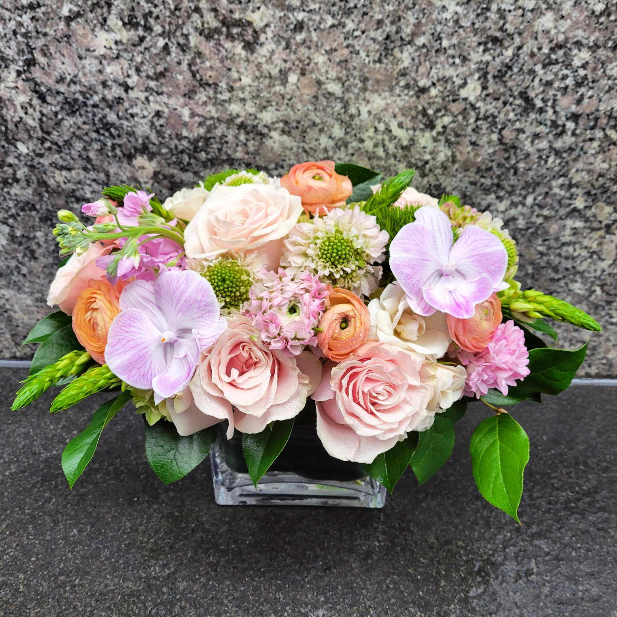 Soft-hued roses, delicate ranunculus, charming scabiosa, and fragrant stock come together in