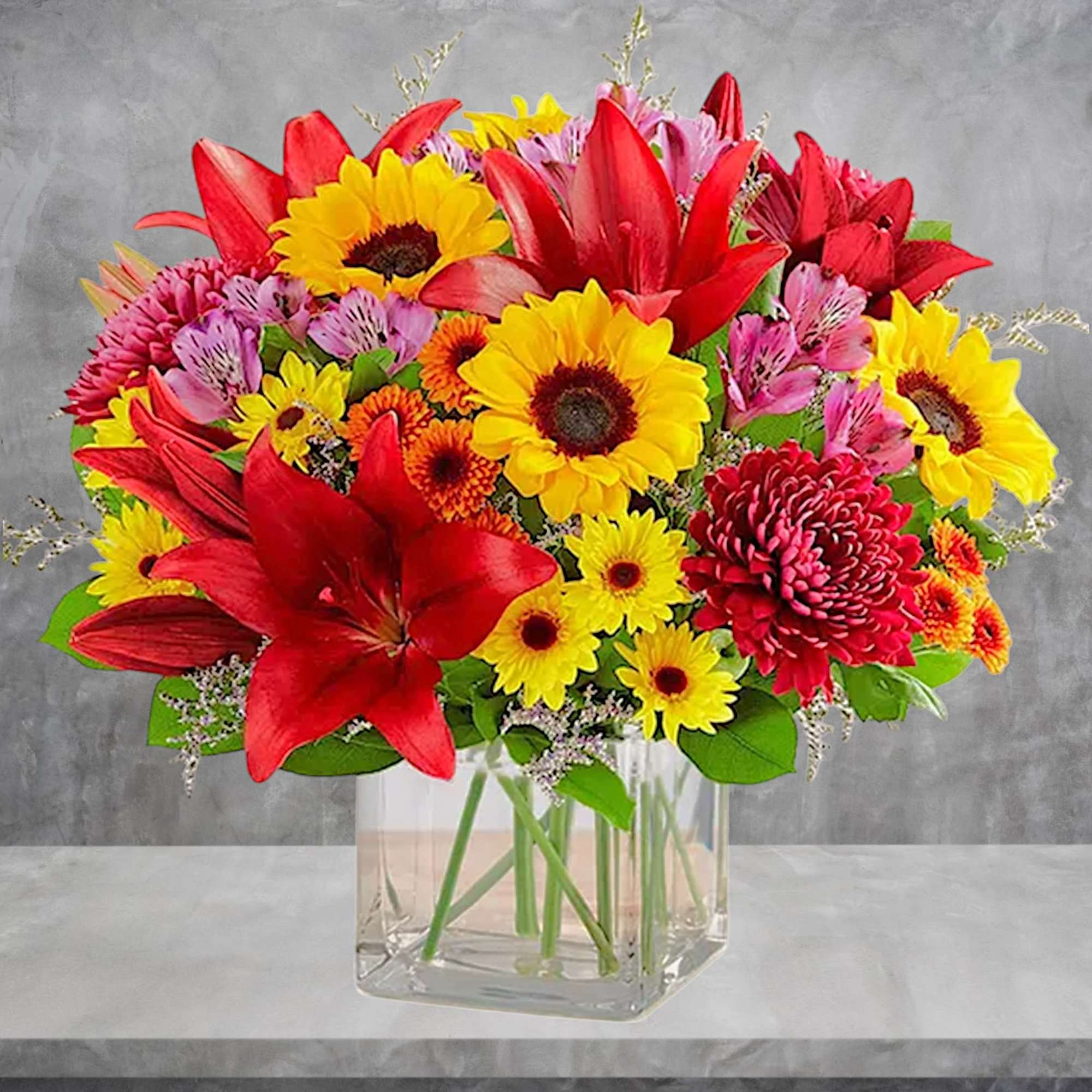 Embrace autumn&rsquo;s allure with our harvest-inspired arrangement. A loose gathering of blooms