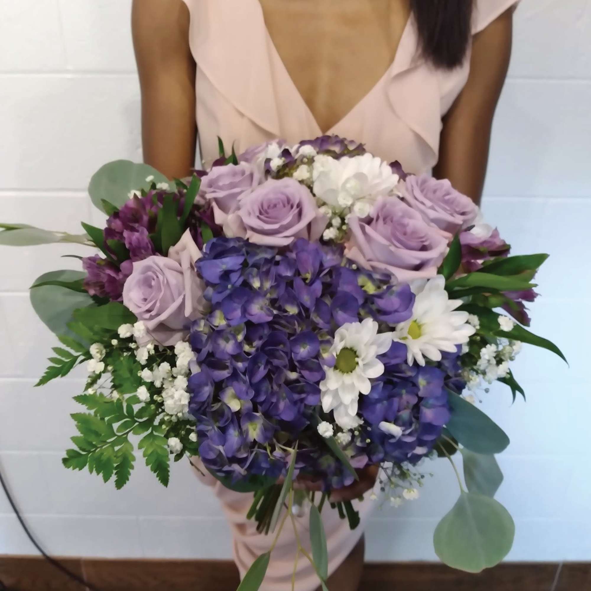 Beautiful shades of purple "cool water" roses, hydrangea and daisies round bridal