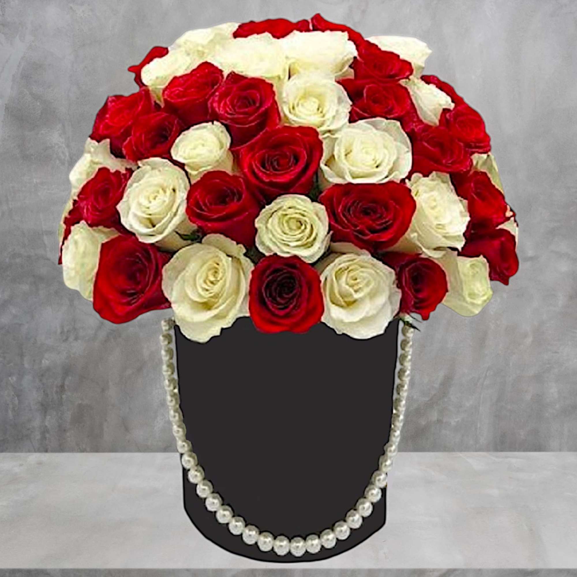 A modern flower arrangement in a heart box filled with roses.

DETAILS
This cylinder