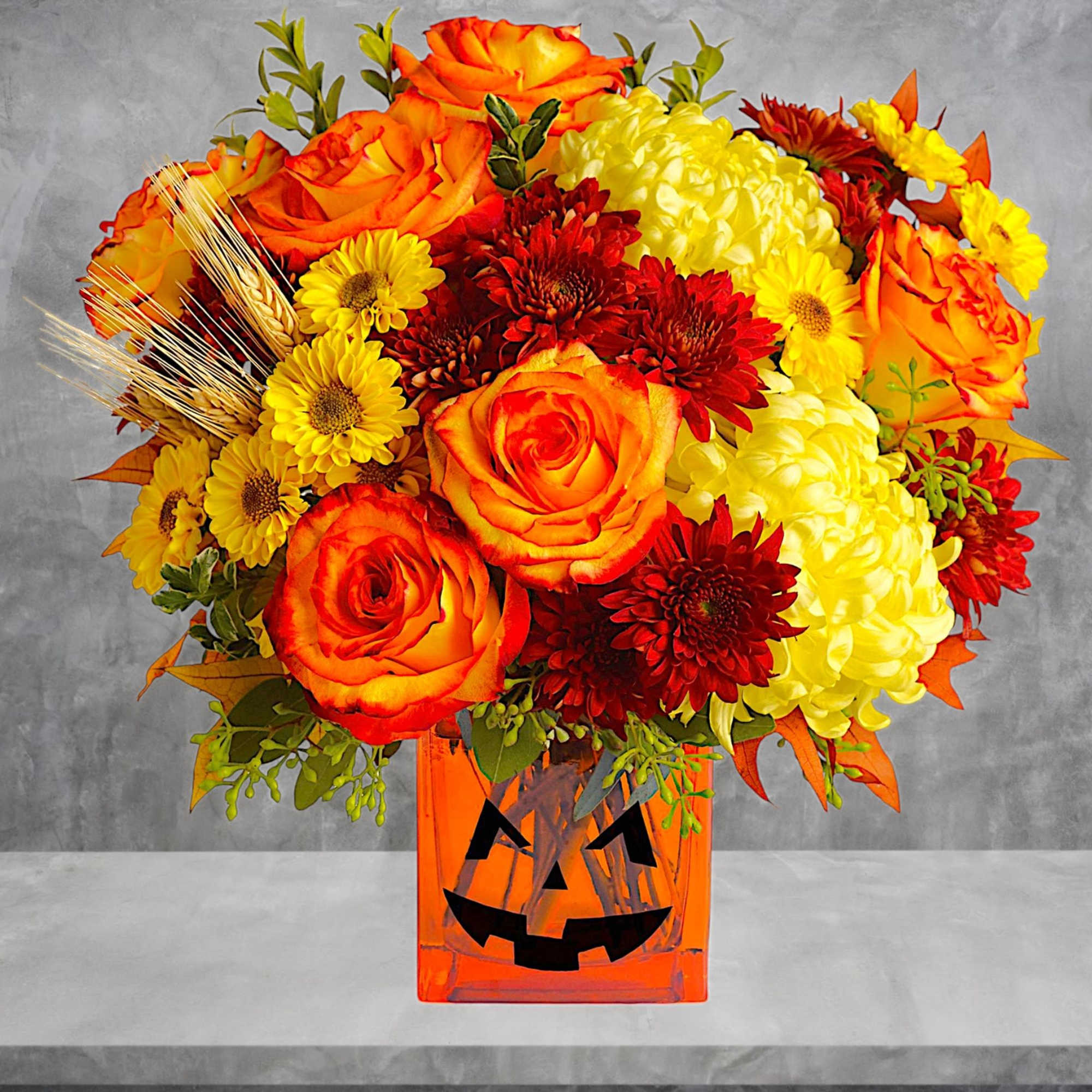 Happy Yellow-een! Yellow chrysanthemums are accented with bright orange roses -all finished