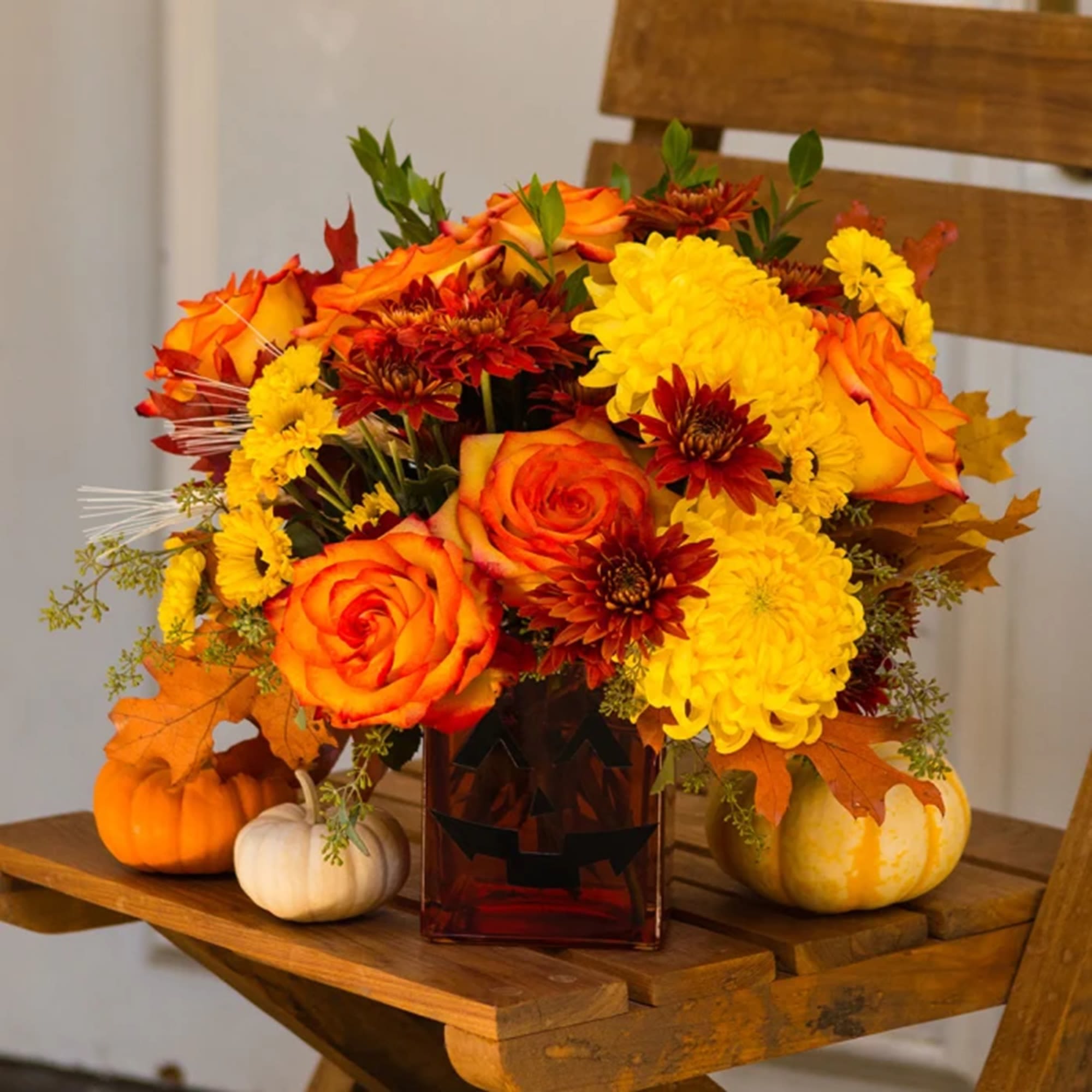Happy Yellow-een! Yellow chrysanthemums are accented with bright orange roses -all finished