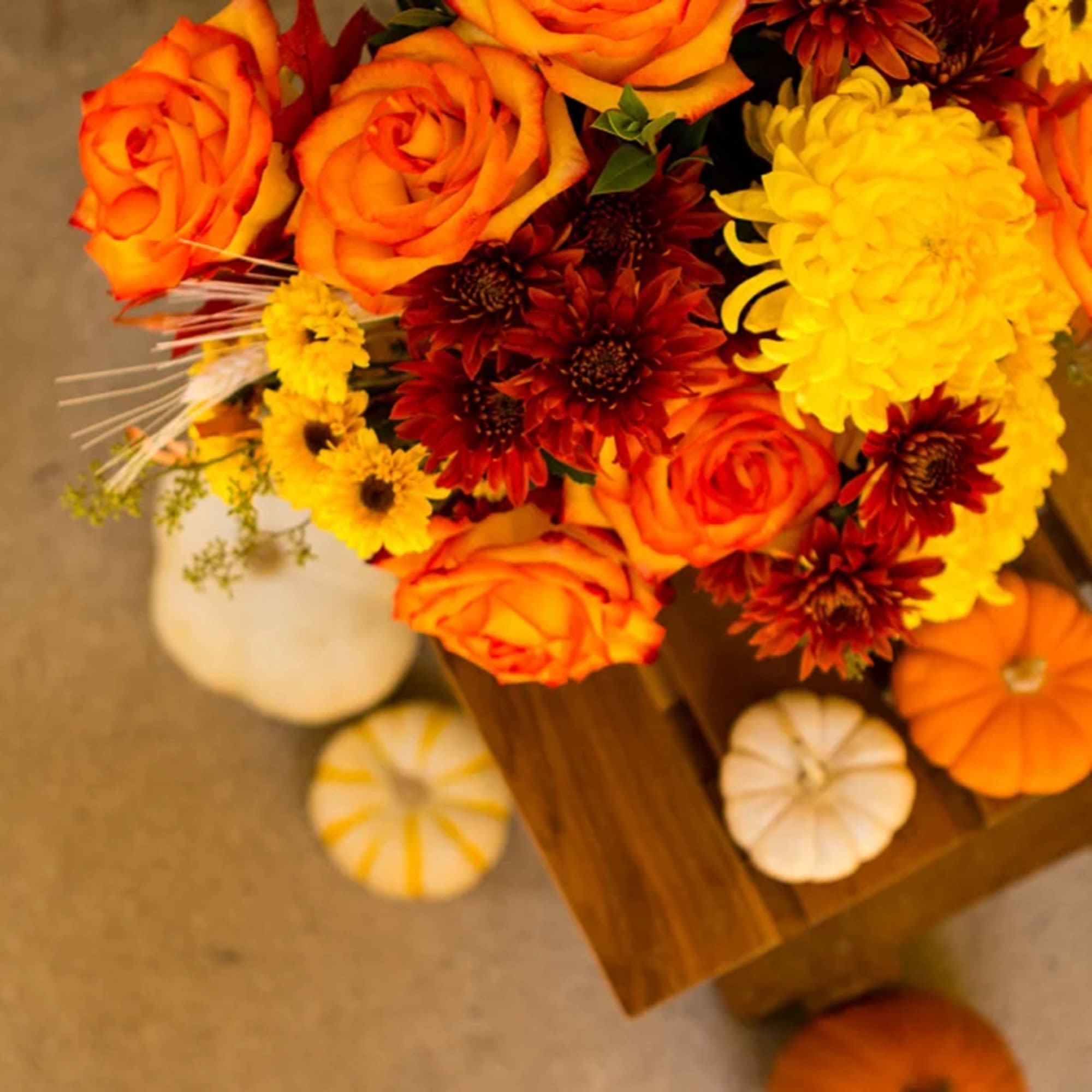 Happy Yellow-een! Yellow chrysanthemums are accented with bright orange roses -all finished