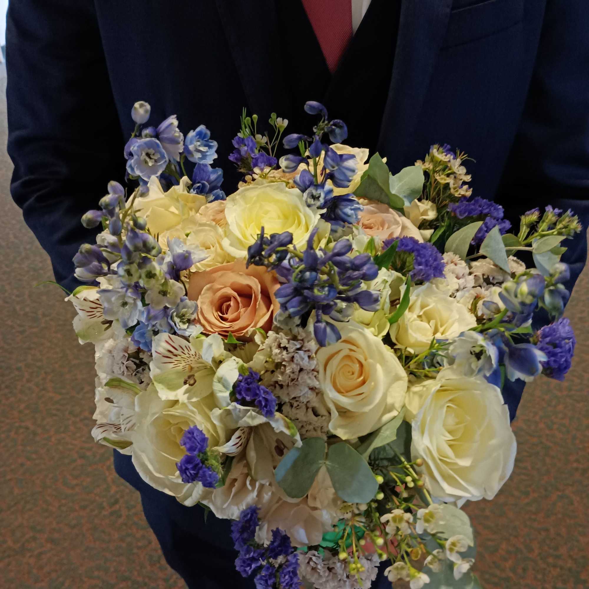 Beautiful genuine mix of light blue delphinium, white and toffee roses, dieses