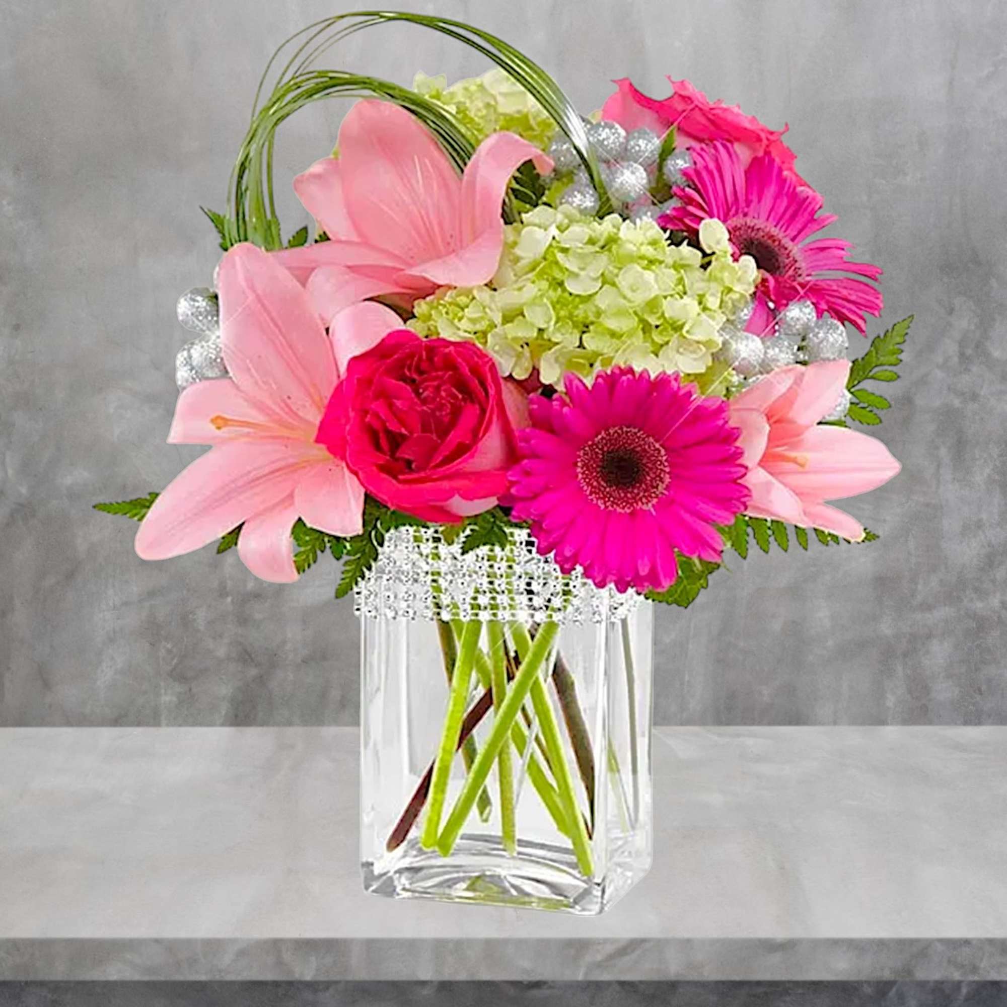 The Blooming Bliss arrangement showcases blushing blooms and definitive style to send