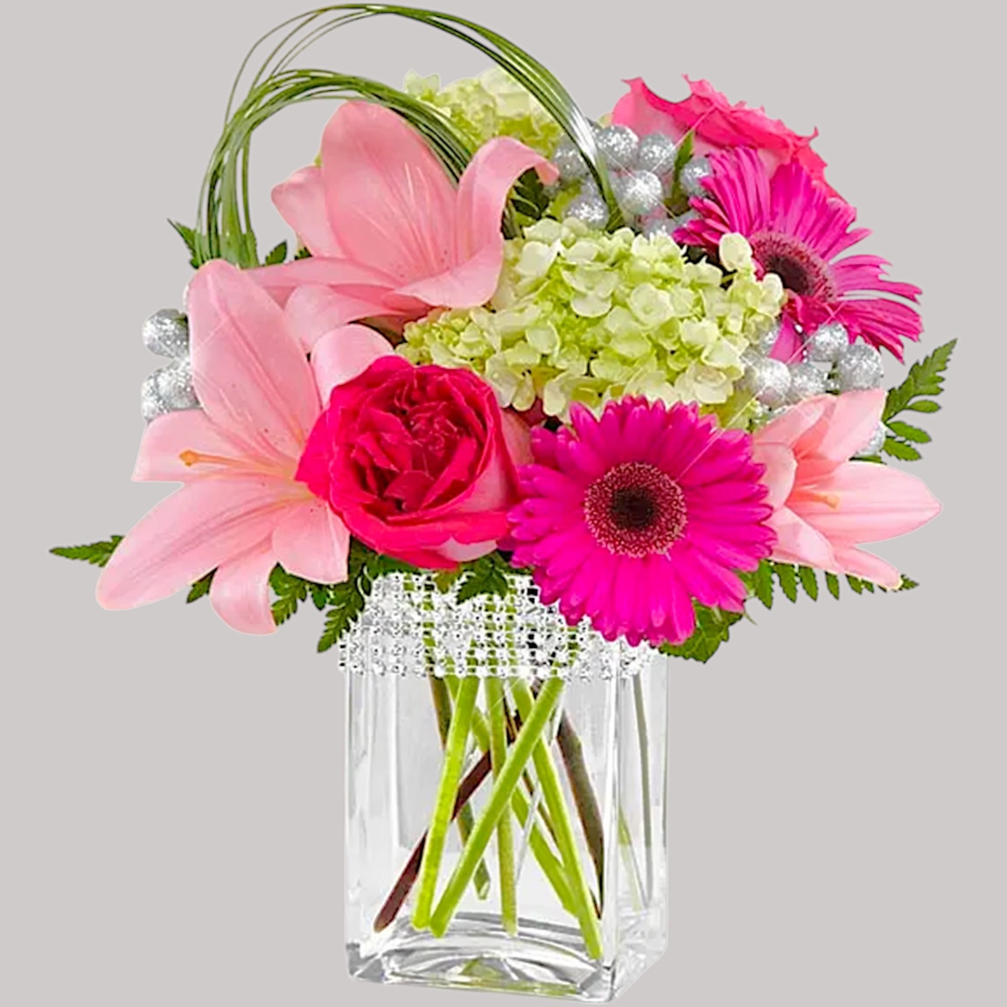 The Blooming Bliss arrangement showcases blushing blooms and definitive style to send