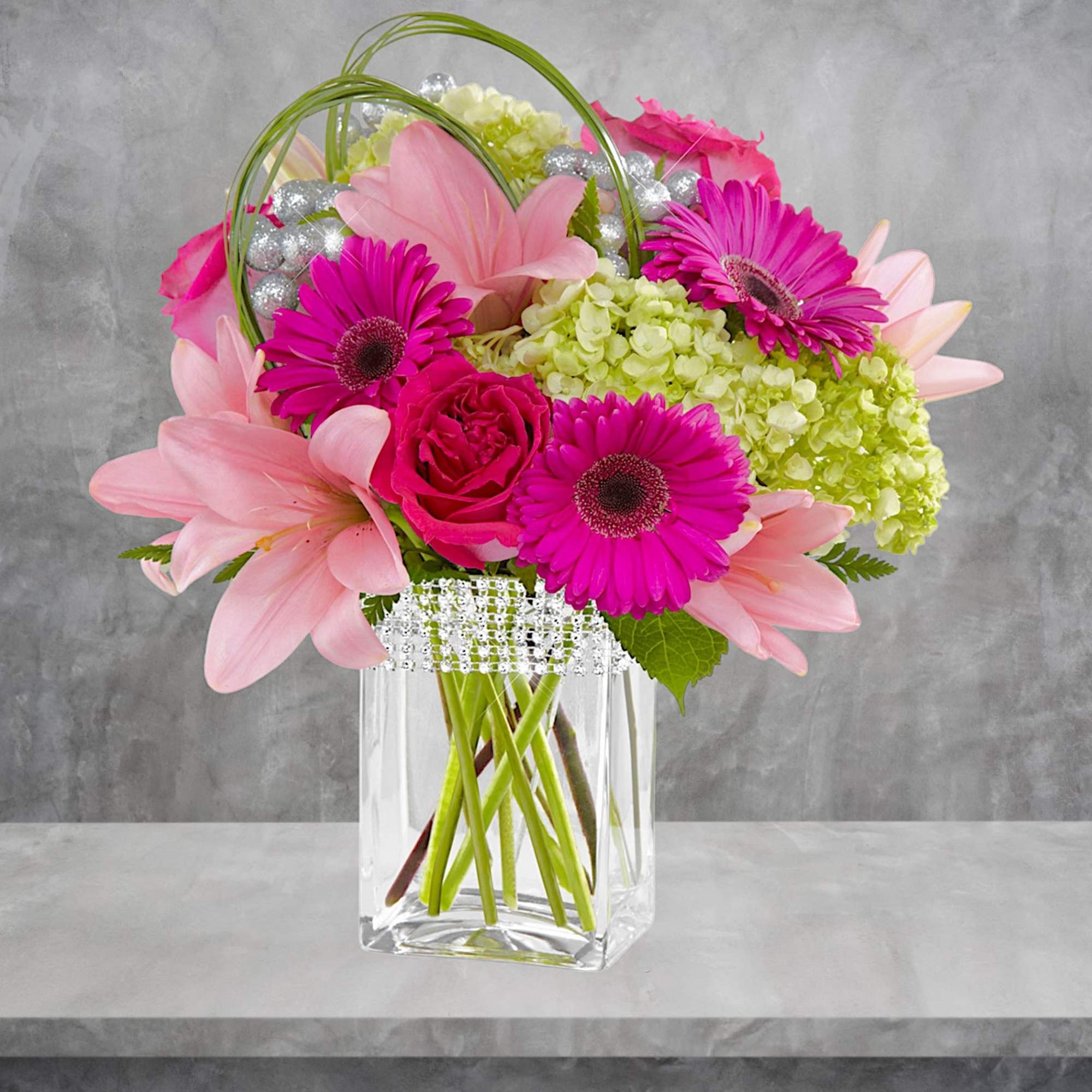 The Blooming Bliss arrangement showcases blushing blooms and definitive style to send
