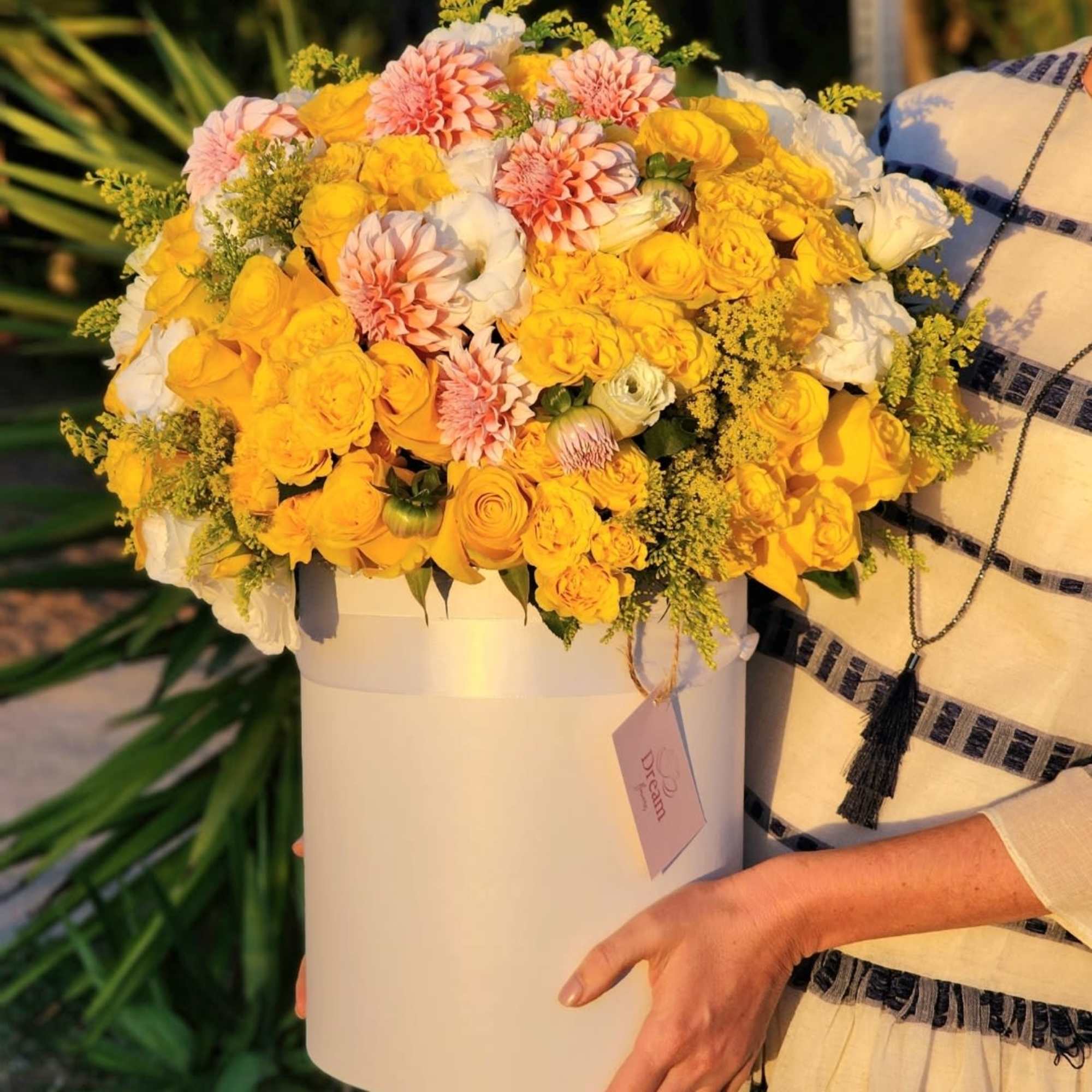 This deluxe floral arrangement features a vibrant mix of yellow and white