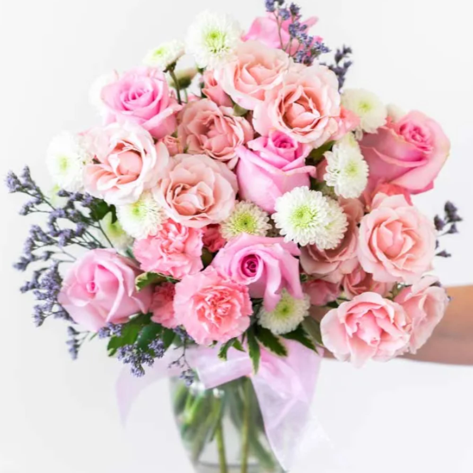 Includes:	
• Pink Roses	
• White Roses	
• Mini Carnations	
• Green Poms	
• Clear Glass Vase Includes:	
• Pink Roses	
• White Roses	
• Mini Carnations	
• Green Poms	
• Clear Glass Vase