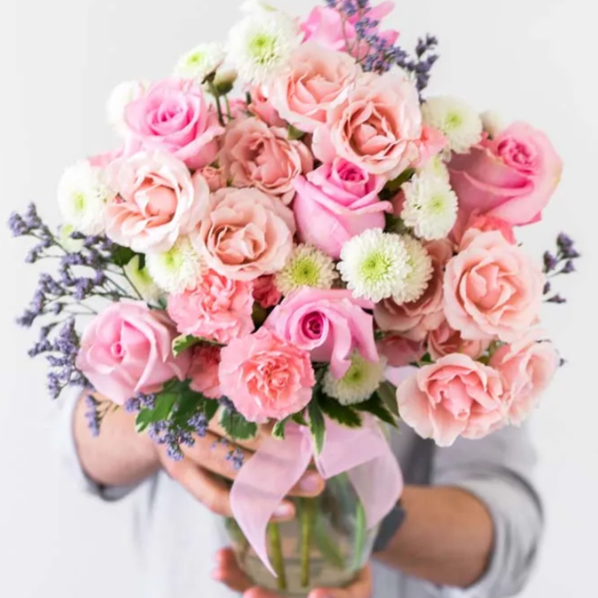 Includes:	
• Pink Roses	
• White Roses	
• Mini Carnations	
• Green Poms	
• Clear Glass Vase Includes:	
• Pink Roses	
• White Roses	
• Mini Carnations	
• Green Poms	
• Clear Glass Vase