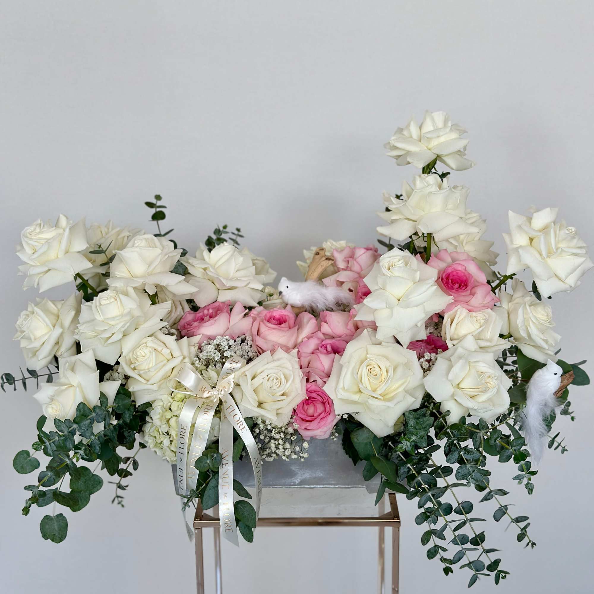Transport yourself to a serene oasis with this arrangement, adorned with delicate