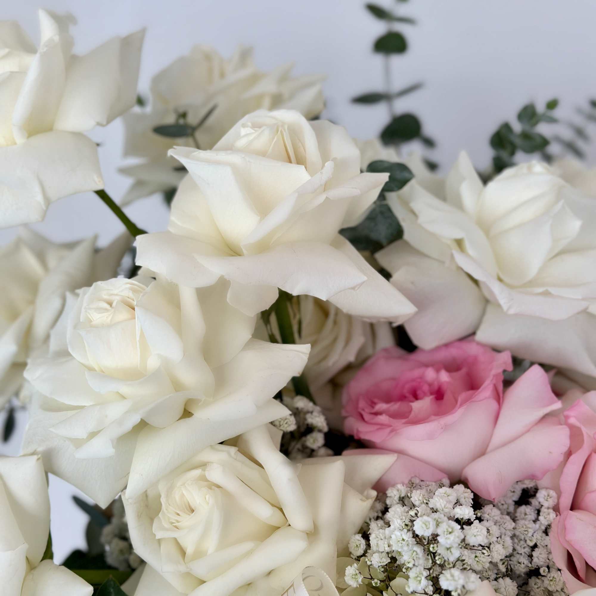 Transport yourself to a serene oasis with this arrangement, adorned with delicate