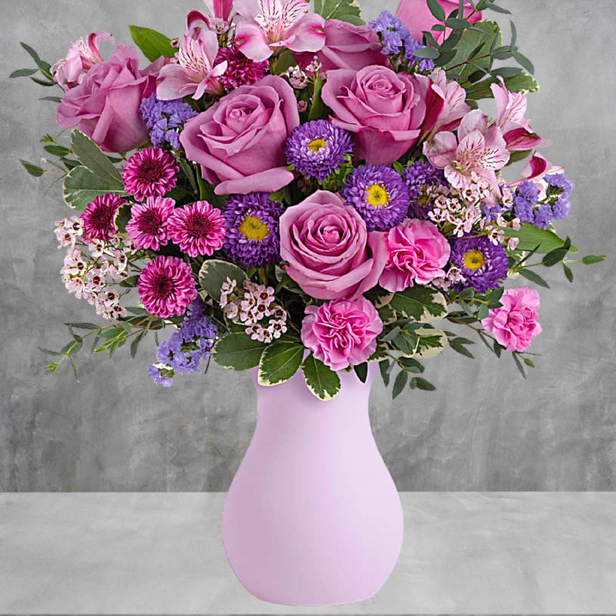 Pretty as a picture, this perfect purple arrangement spoils your someone special